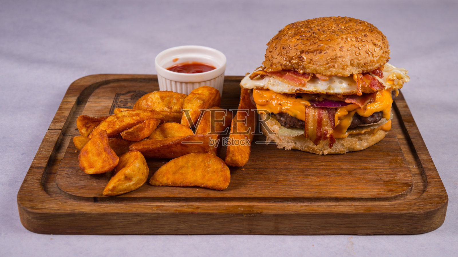 汉堡配肉排，培根，奶酪，炸土豆和番茄酱照片摄影图片