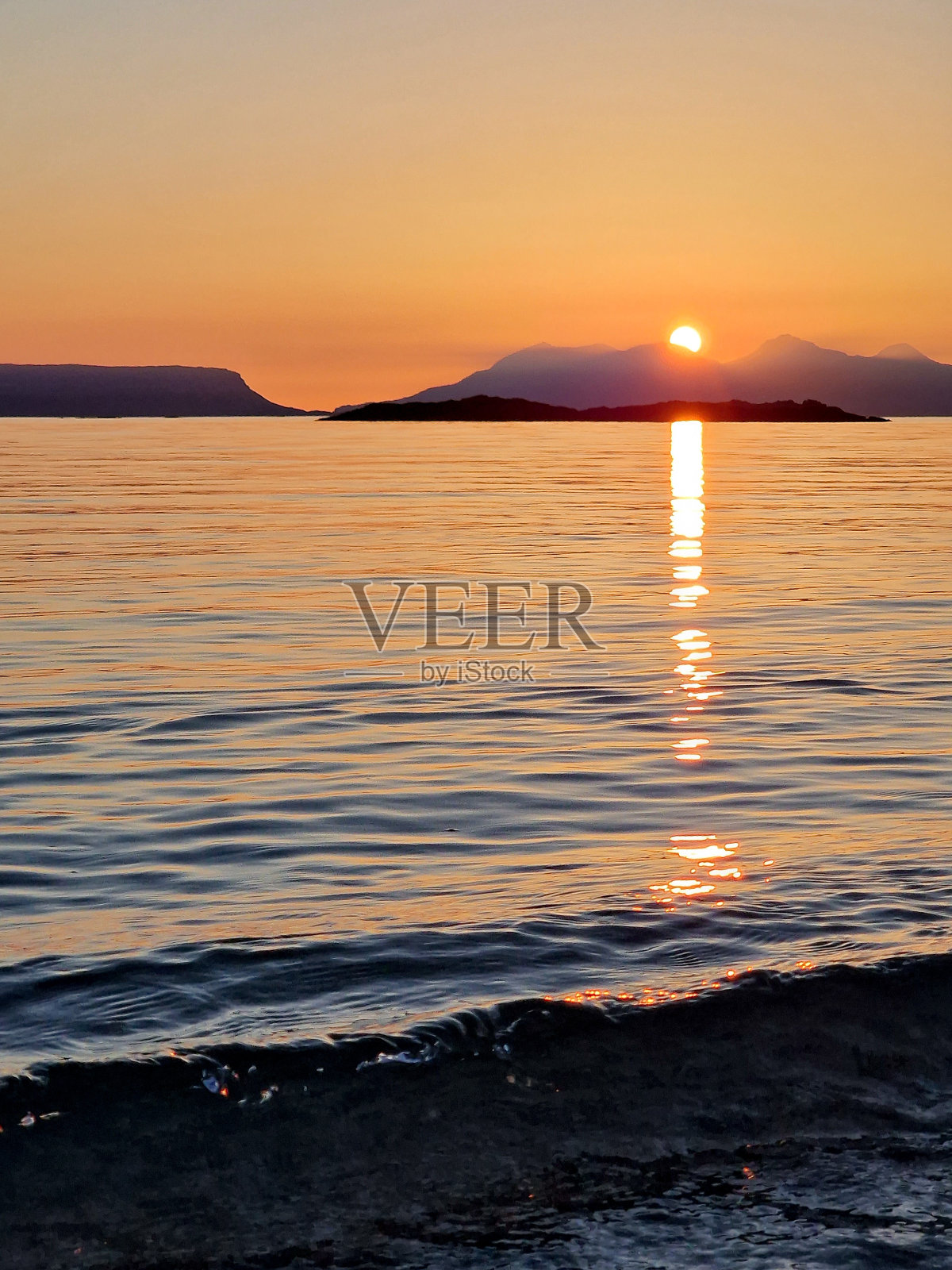 太阳从阿里赛海滩的岛屿后面落下照片摄影图片