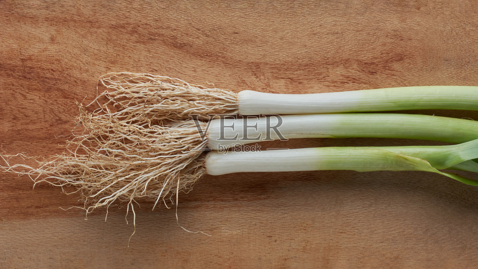 切菜板上有根的韭菜特写照片摄影图片