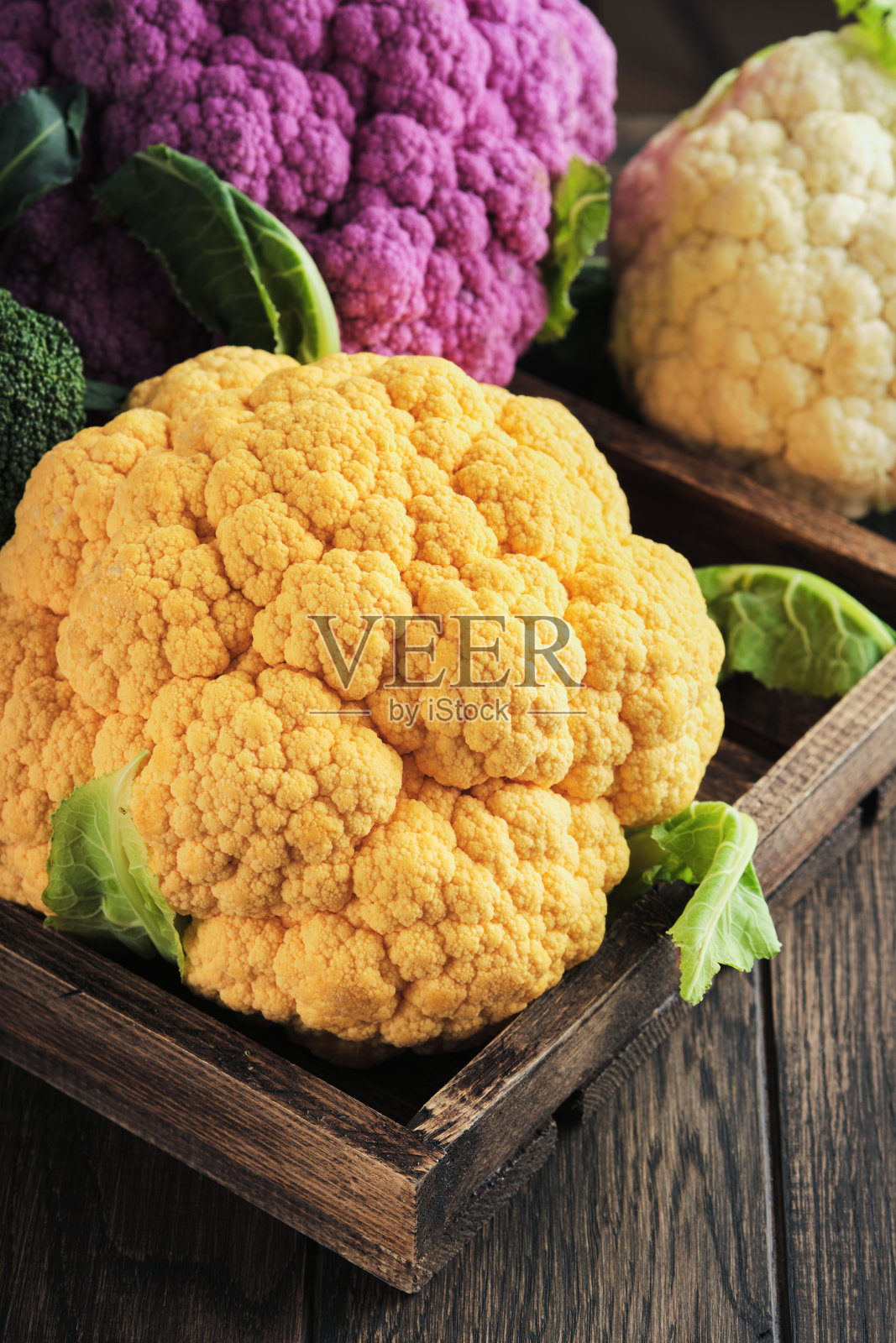 Colorfu菜花。各种各样的菜花在古老的木头背景上。紫色、黄色、白色和绿色的卷心菜。西兰花和叫romesco。农业收成。模拟。照片摄影图片