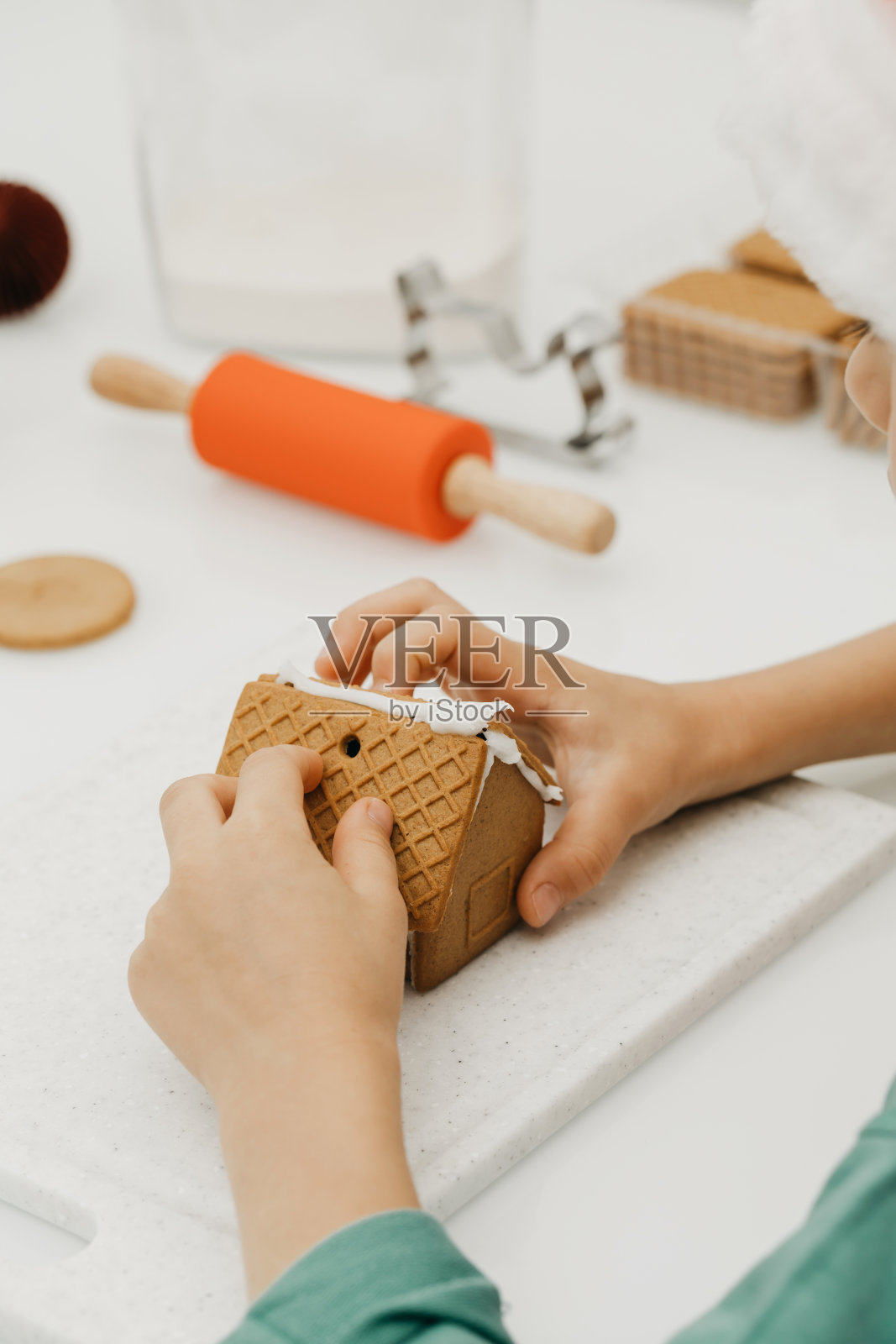 小孩在厨房里制作姜饼屋，圣诞节假日照片摄影图片