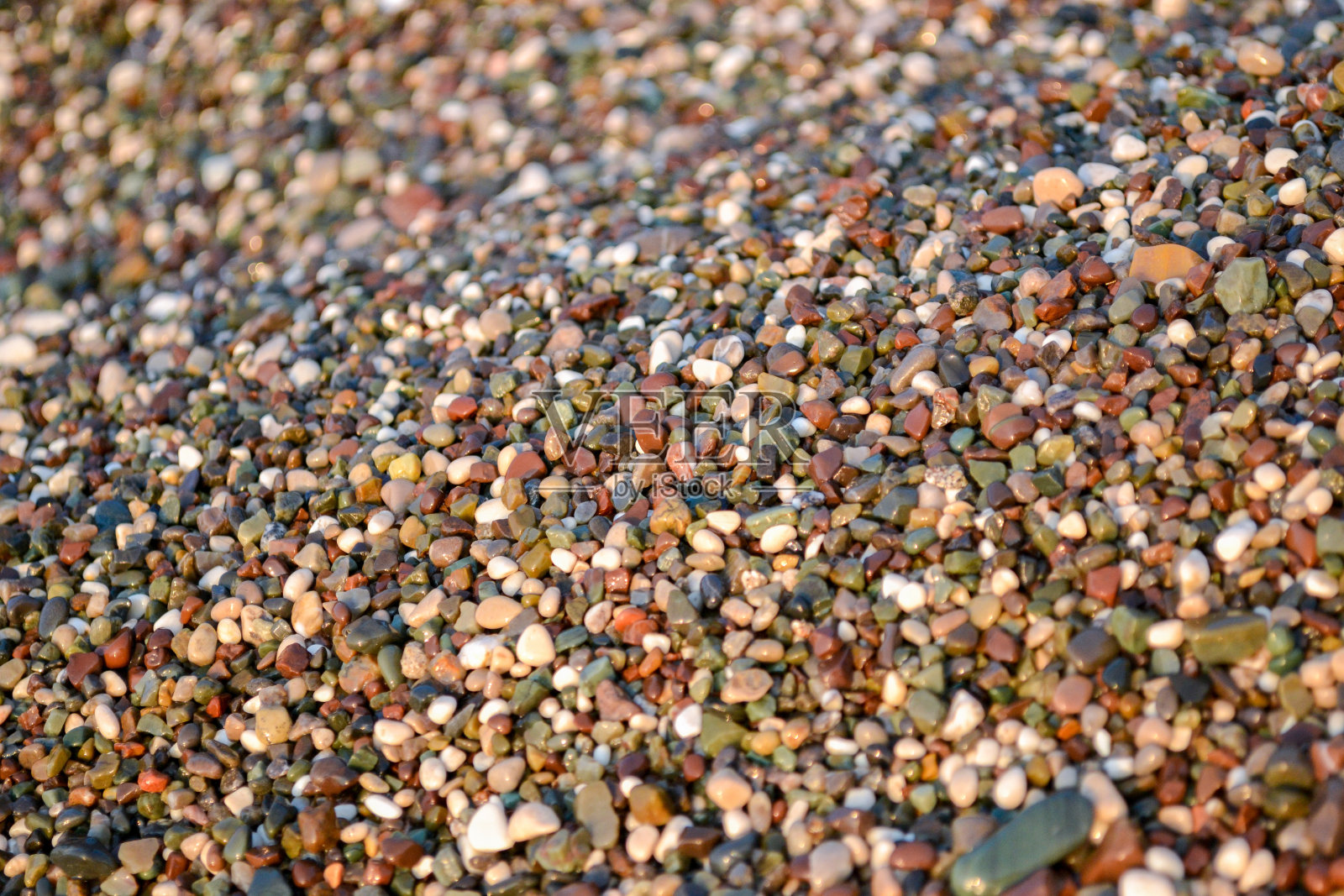 土耳其海滩上美丽的小石子纹理。背景照片摄影图片
