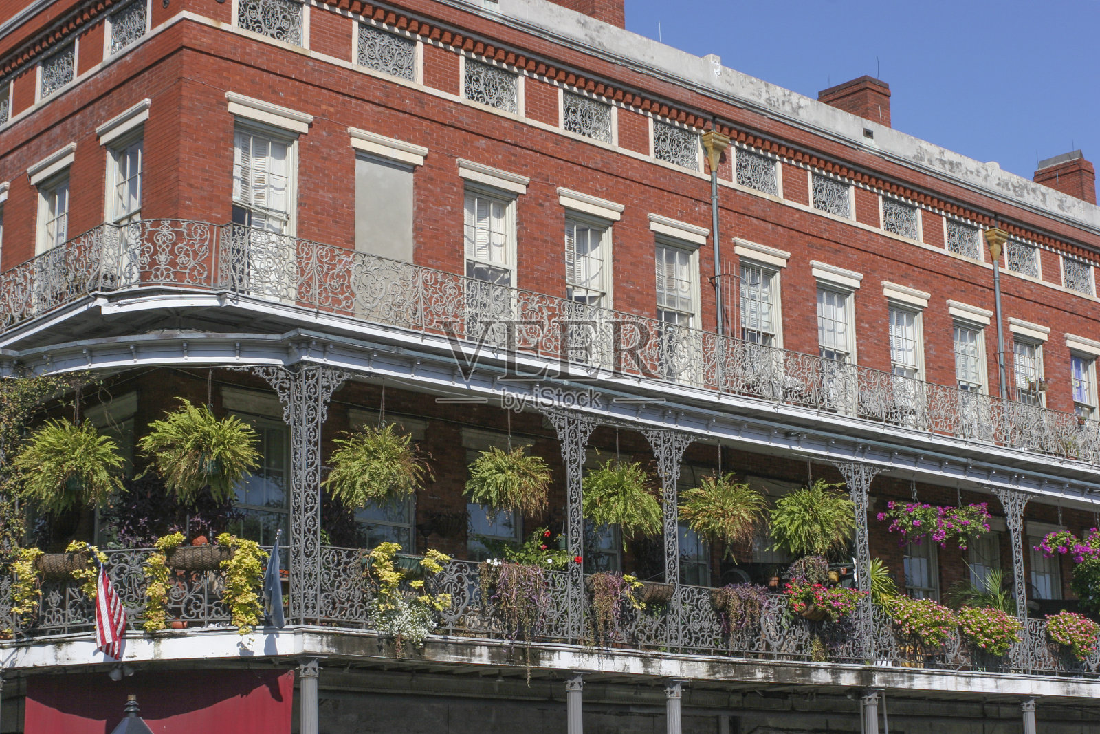 新奥尔良的法国区建筑，典型的砖外墙，画廊或阳台和悬挂蕨类植物。照片摄影图片