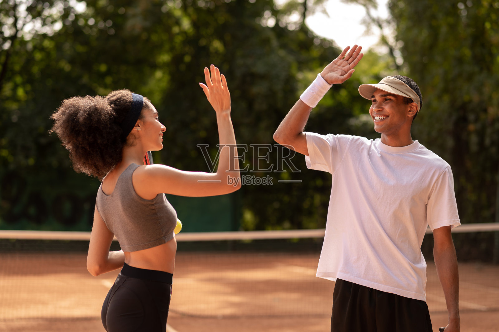 年轻的网球运动员在网球场锻炼照片摄影图片