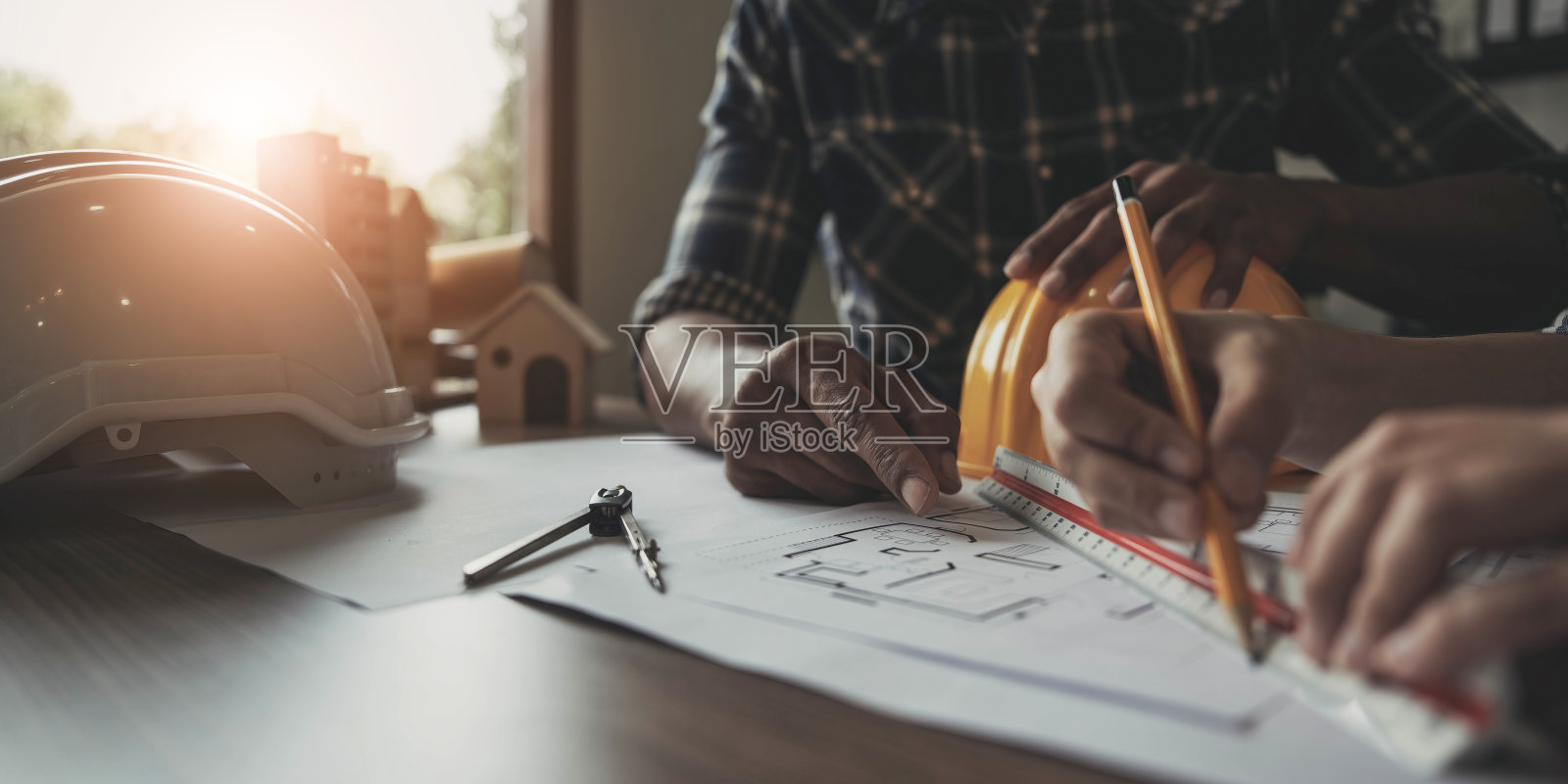 建筑商两个年轻的亚洲工程师和一个女建筑师正在讨论在现场建造一个工业工厂的计划。工人的概念。照片摄影图片