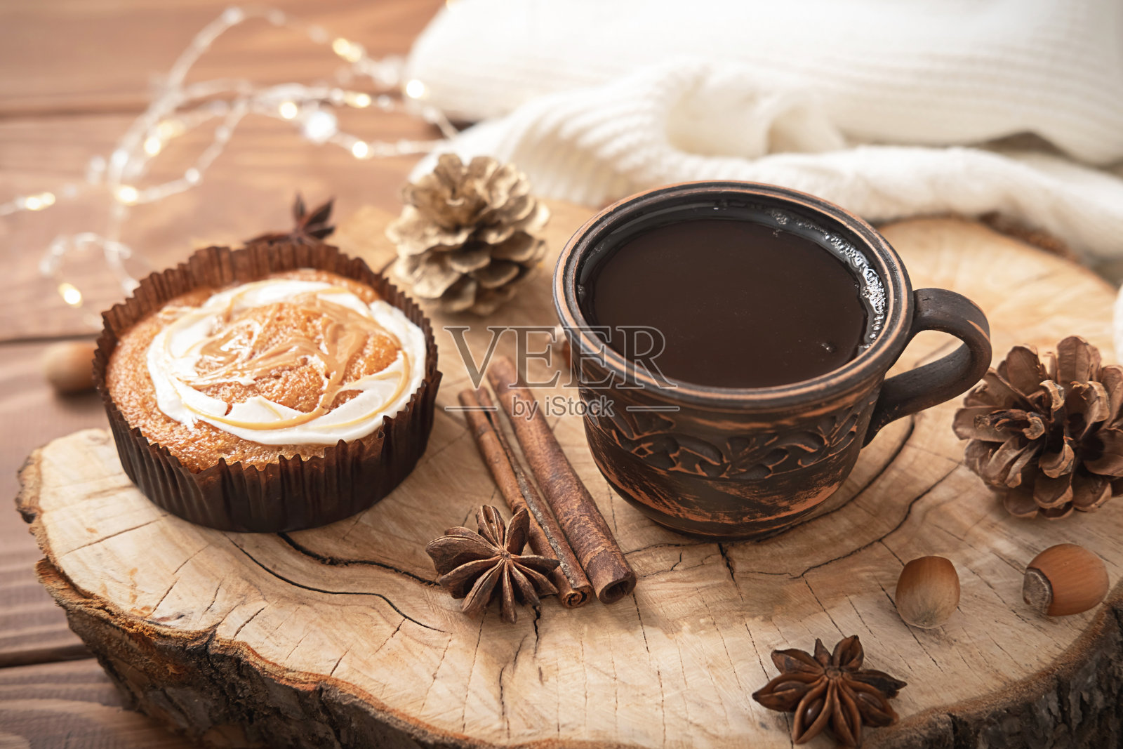 一杯芳香的黑咖啡，浓缩咖啡或茶与香料和香甜可口的蛋糕在木制站立的桌子上。家的概念舒适，温馨，冬秋的心情。照片摄影图片