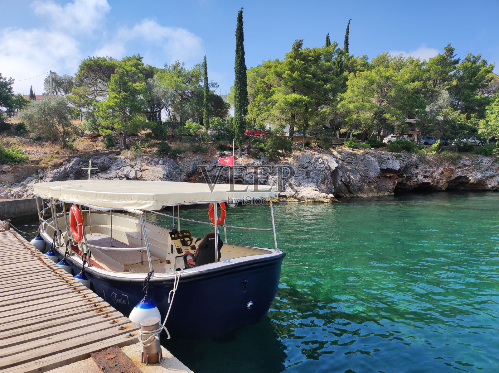 码头边的空船，背景是岩石海岸。黑山。照片摄影图片