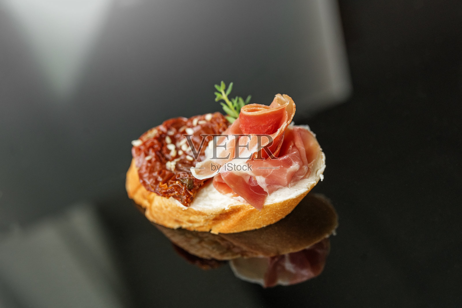 开胃菜配熏火腿，意式烤面包和晒干的番茄。食物，餐厅和活动概念。照片摄影图片