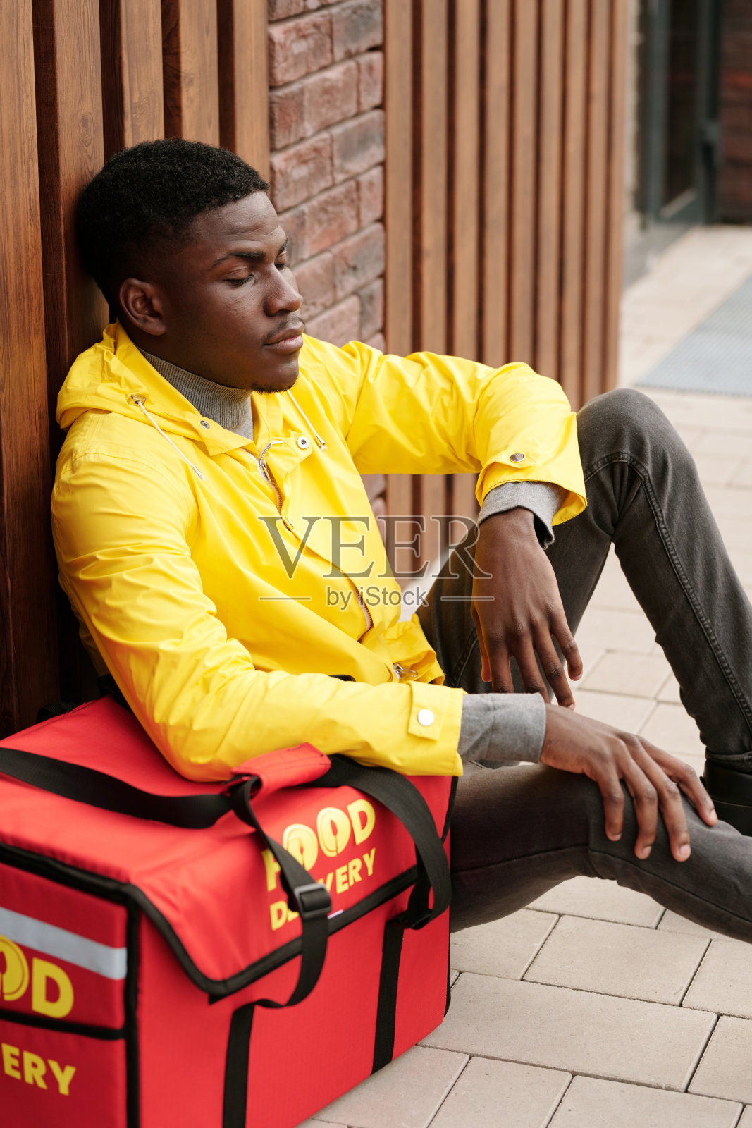 非裔美国男性快递员闭着眼睛的侧视图照片摄影图片