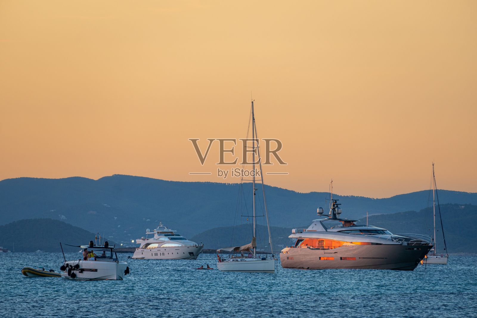 西班牙福门特拉日出时的海上游艇照片摄影图片