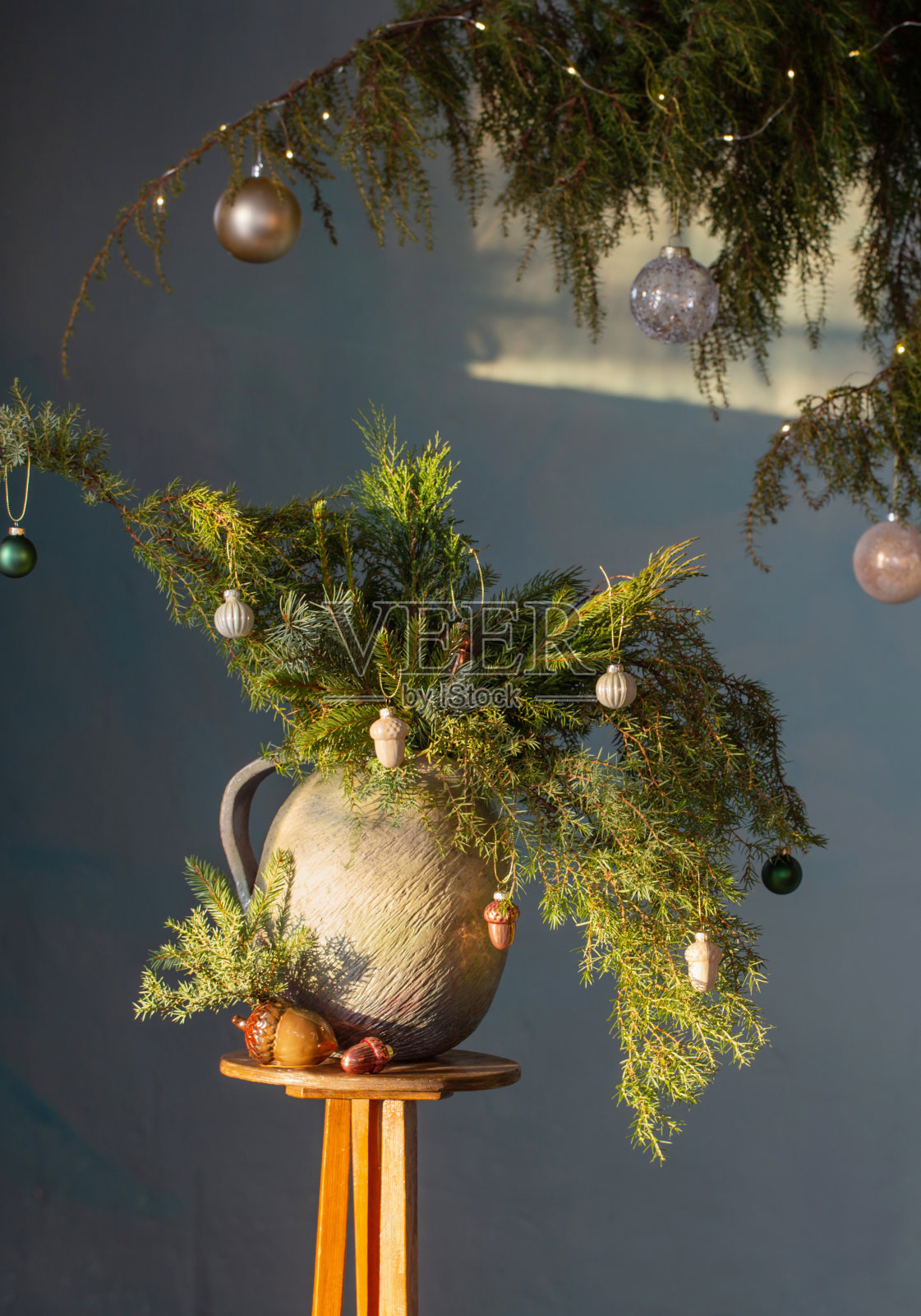 圣诞常绿树枝在陶瓷复古壶上绿色背景照片摄影图片