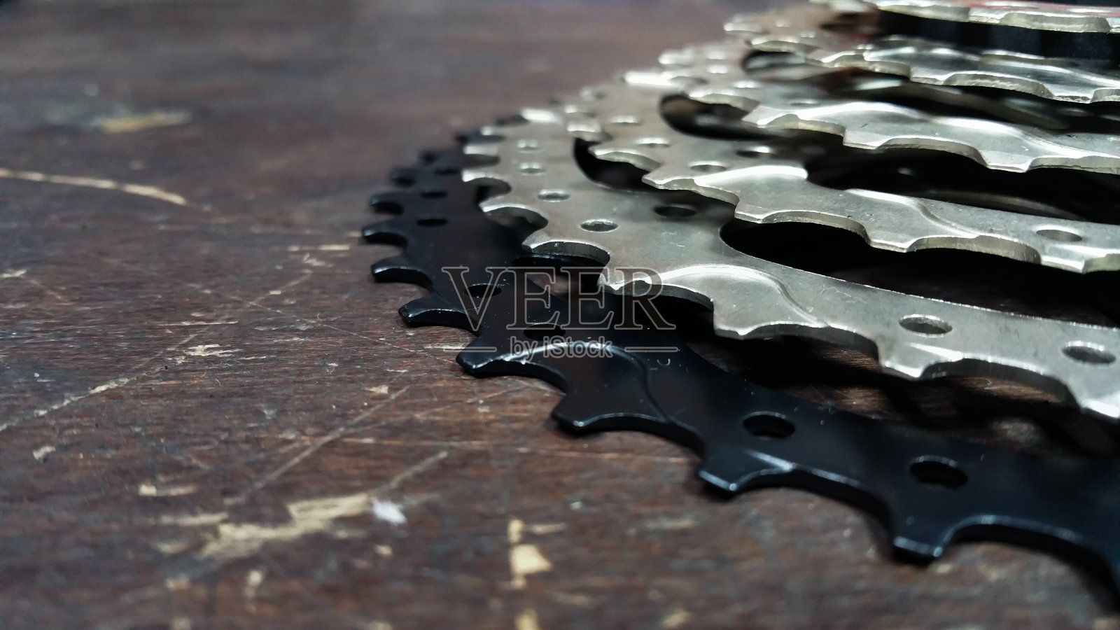 明星从一个10速后自行车卡带-特写在一个黑色的木制背景照片摄影图片