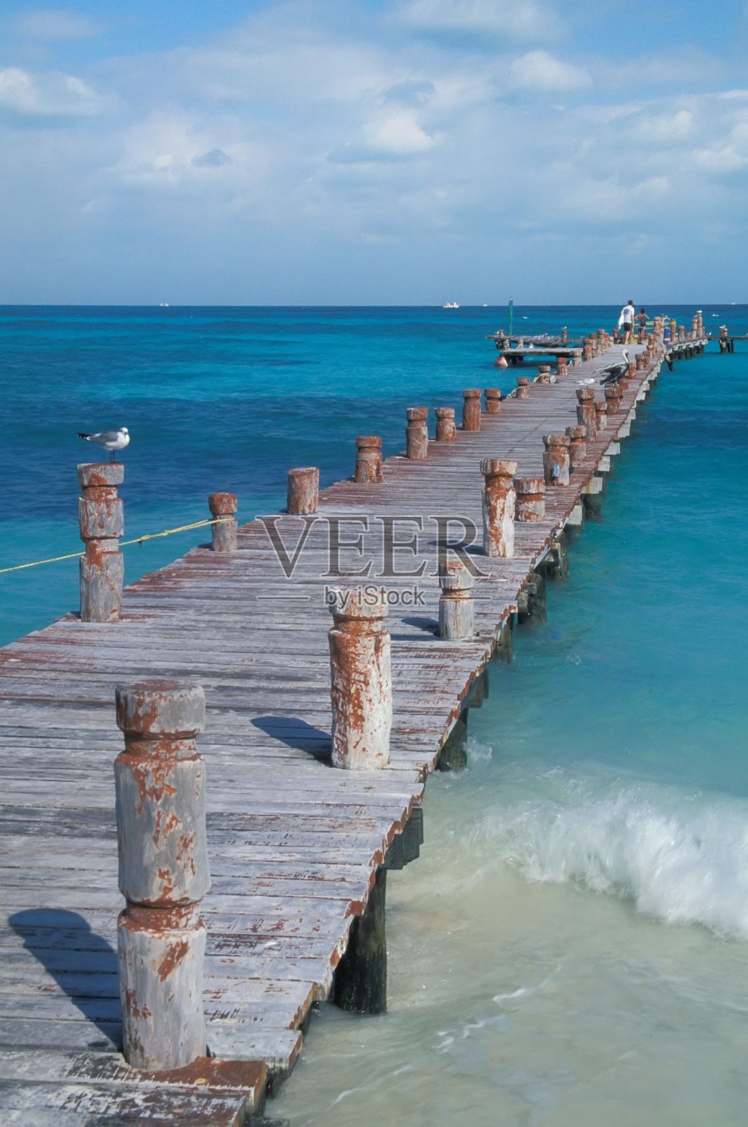 在阳光明媚的日子里，宁静的蓝色大海和木制码头的美丽景色照片摄影图片