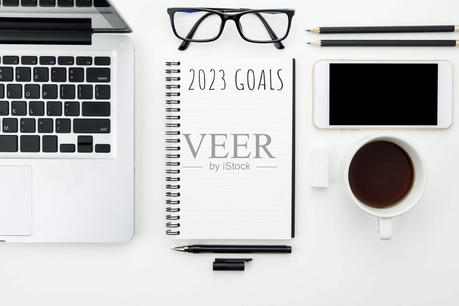 把2023年的目标写在笔记本上，写上新年的决心和计划。照片摄影图片