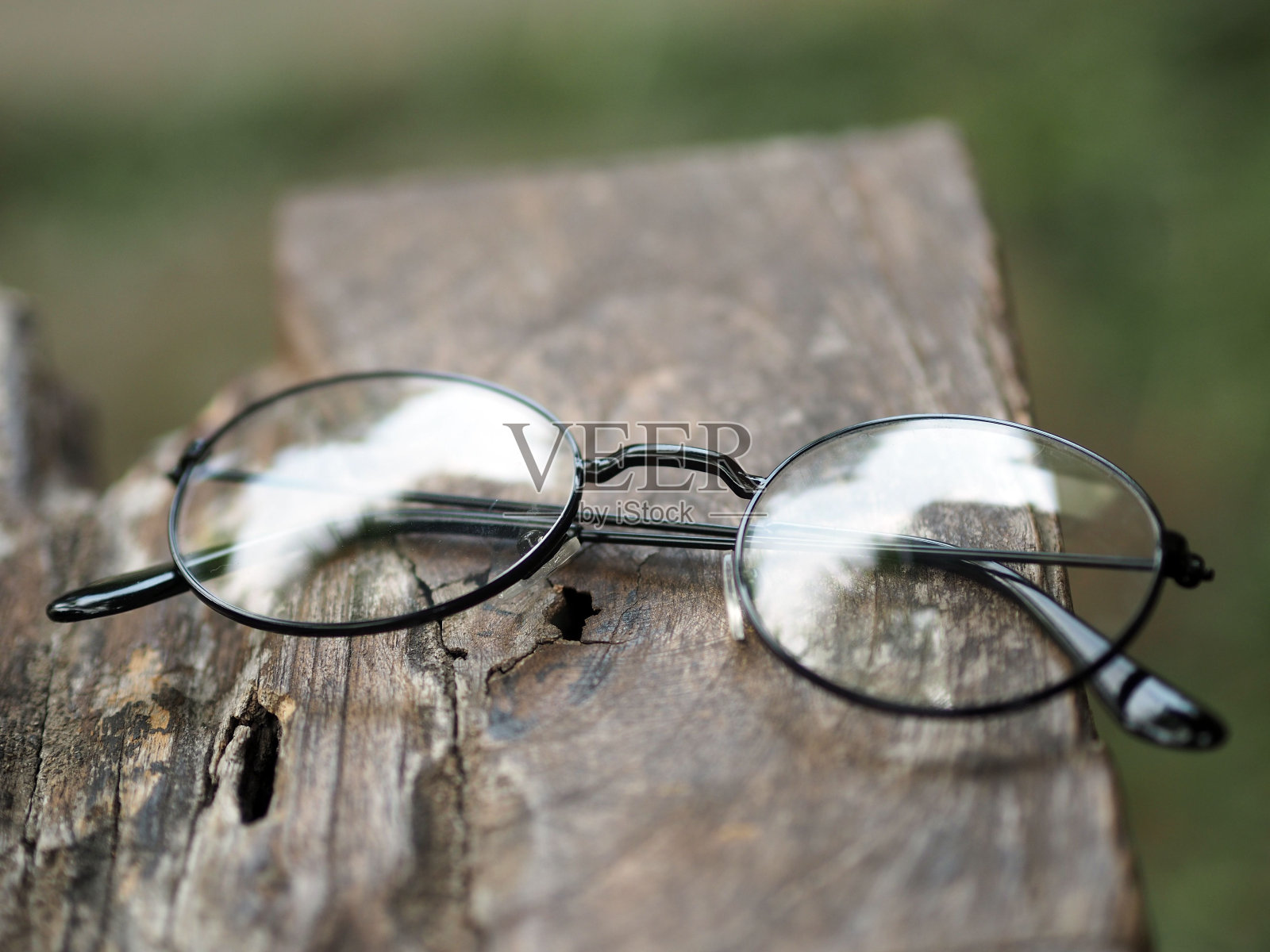 透明眼镜的特写与圆形框架的木质表面照片摄影图片