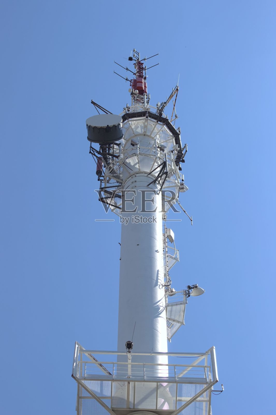 蓝色天空下的无线电广播桅杆的垂直镜头照片摄影图片