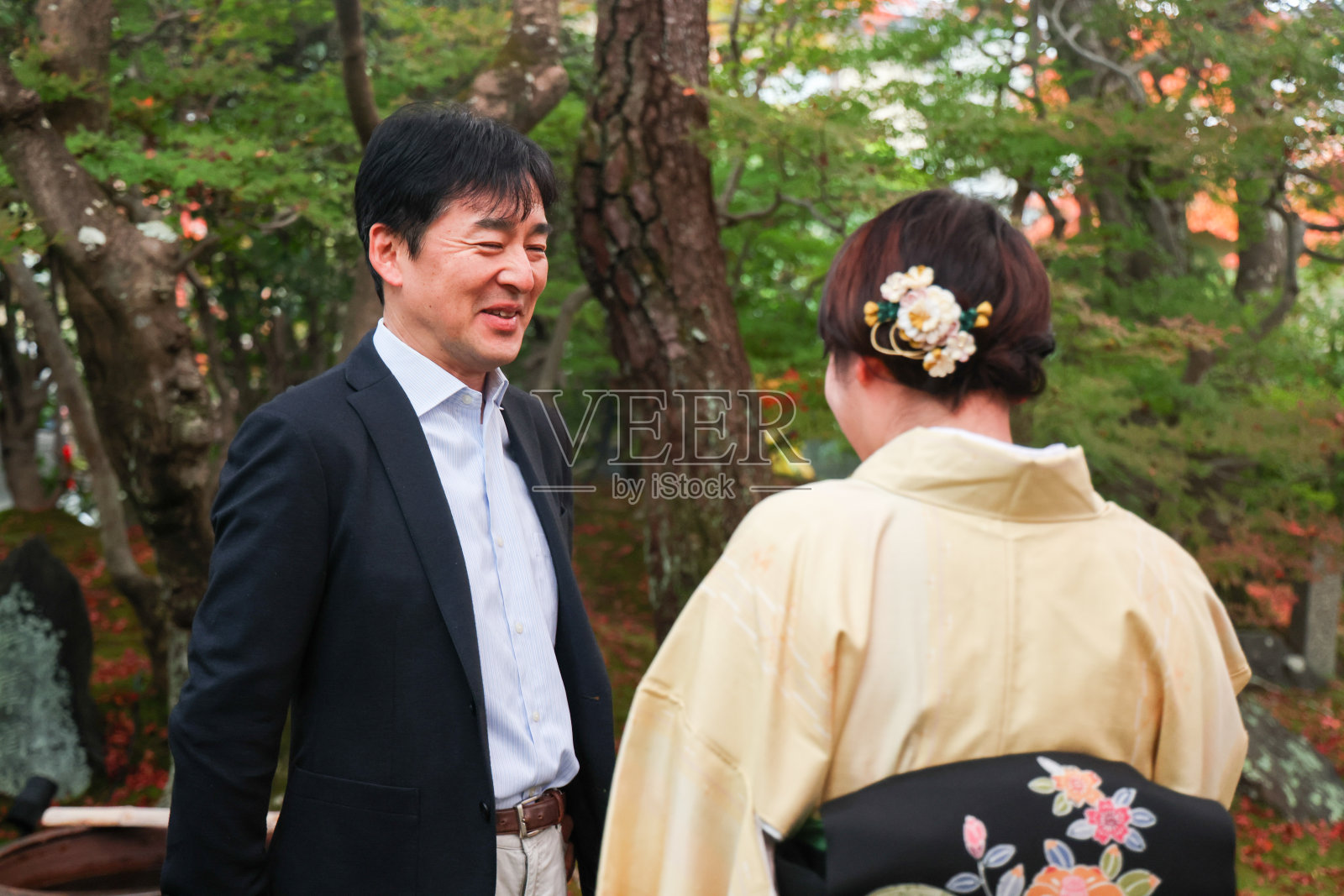 日本夫妇在传统的日本花园欣赏秋叶照片摄影图片