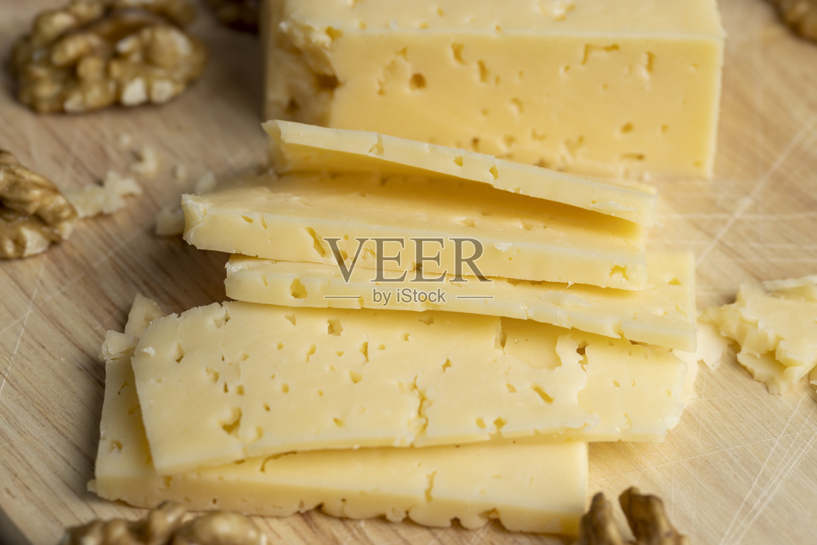 带洞和核桃的硬奶酪切片照片摄影图片