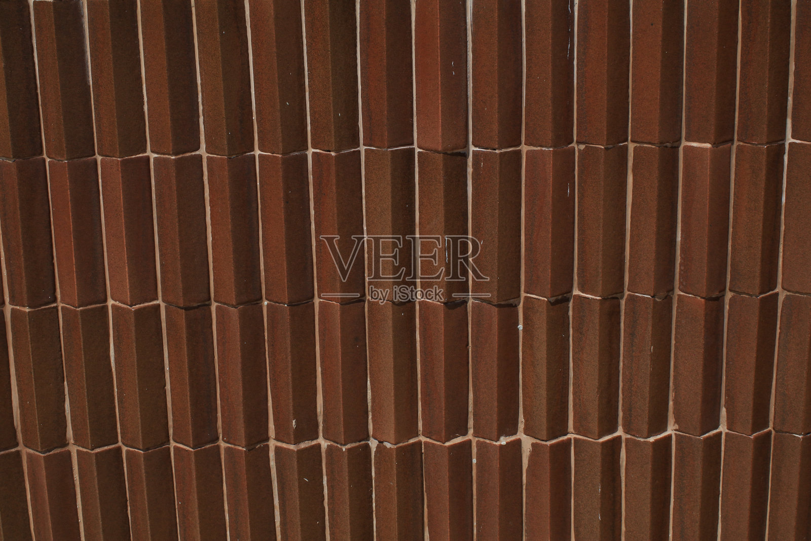 棕色瓷砖墙的纹理和背景。房间装饰复古。室内、室外陶瓷墙砖和地板照片摄影图片