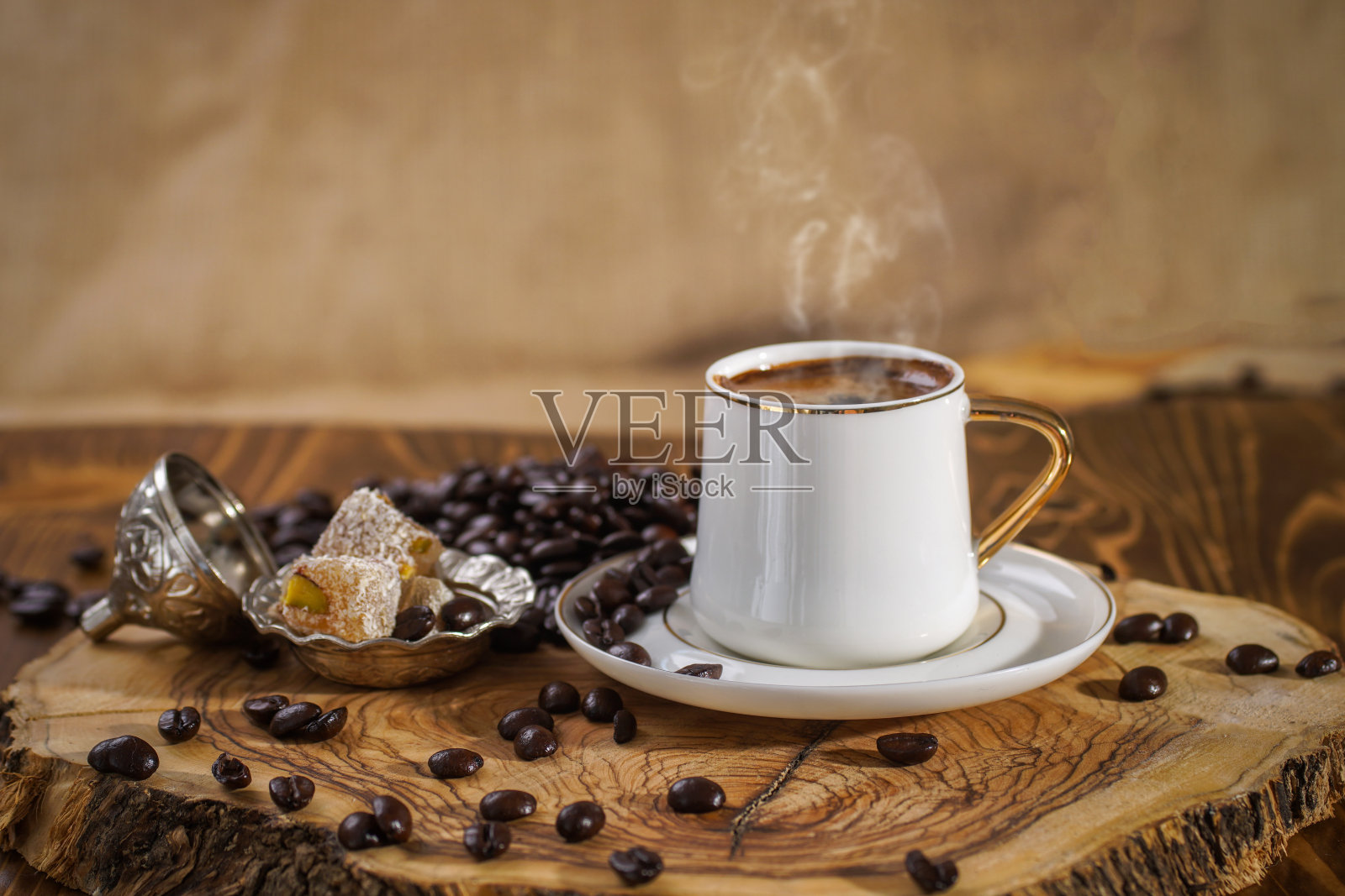 木地板上放着热土耳其咖啡，旁边放着土耳其软糖。照片摄影图片