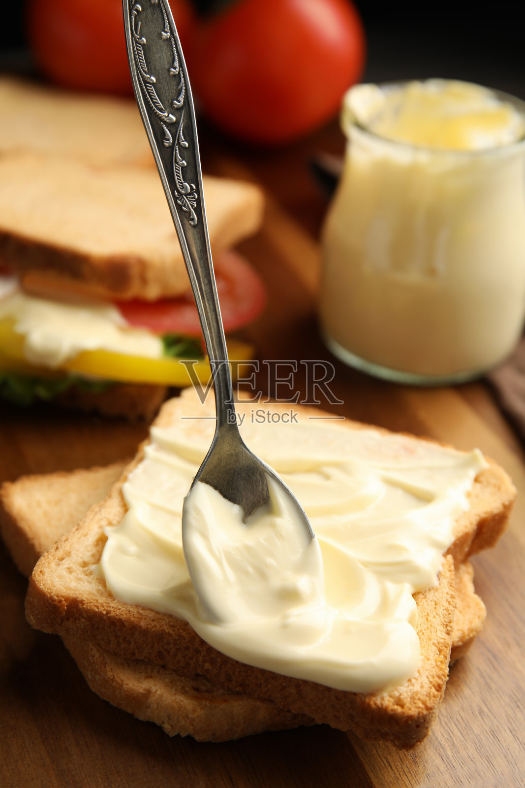 木桌上的面包片和蛋黄酱，特写照片摄影图片