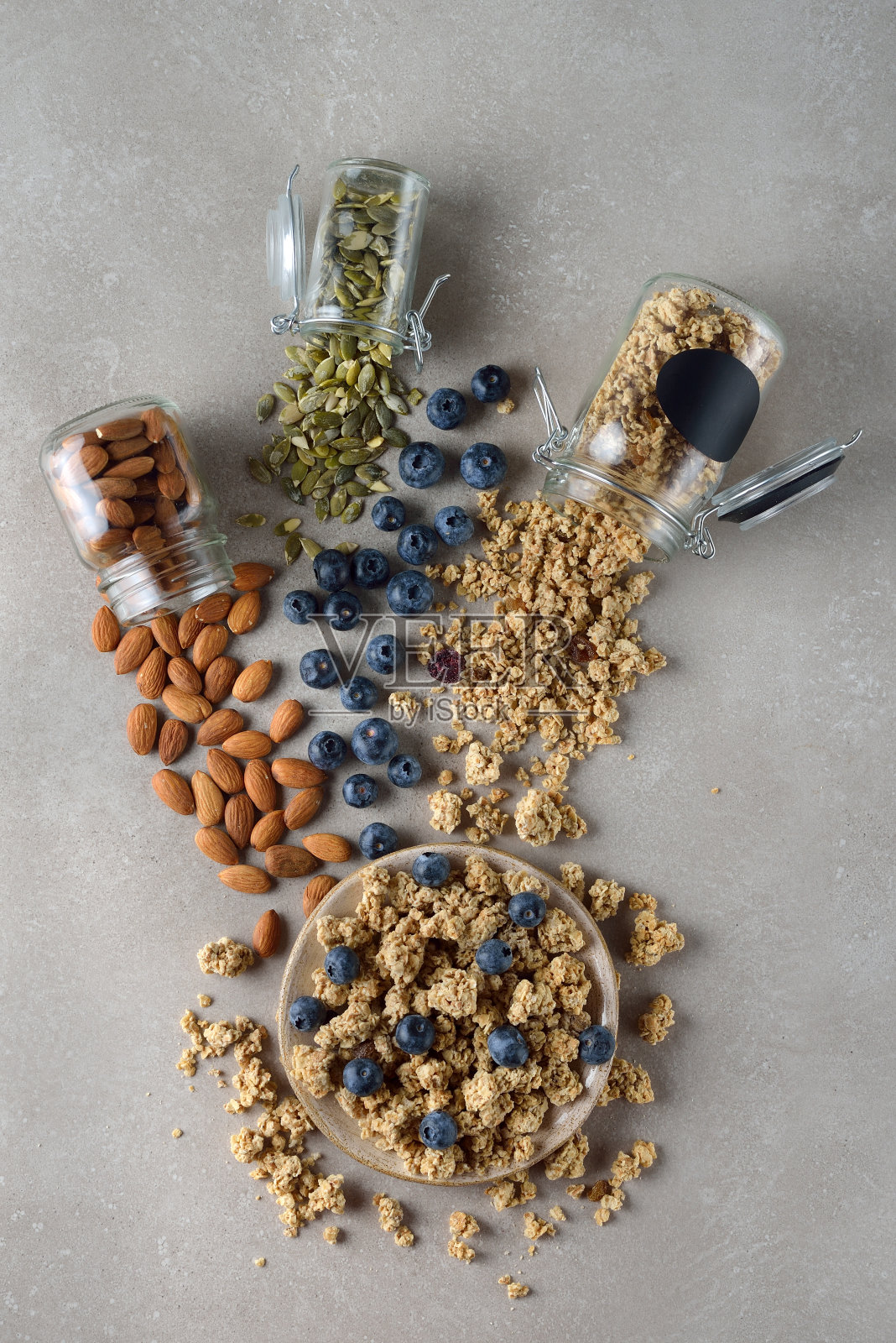 灰色背景上有格兰诺拉麦片、种子和浆果照片摄影图片