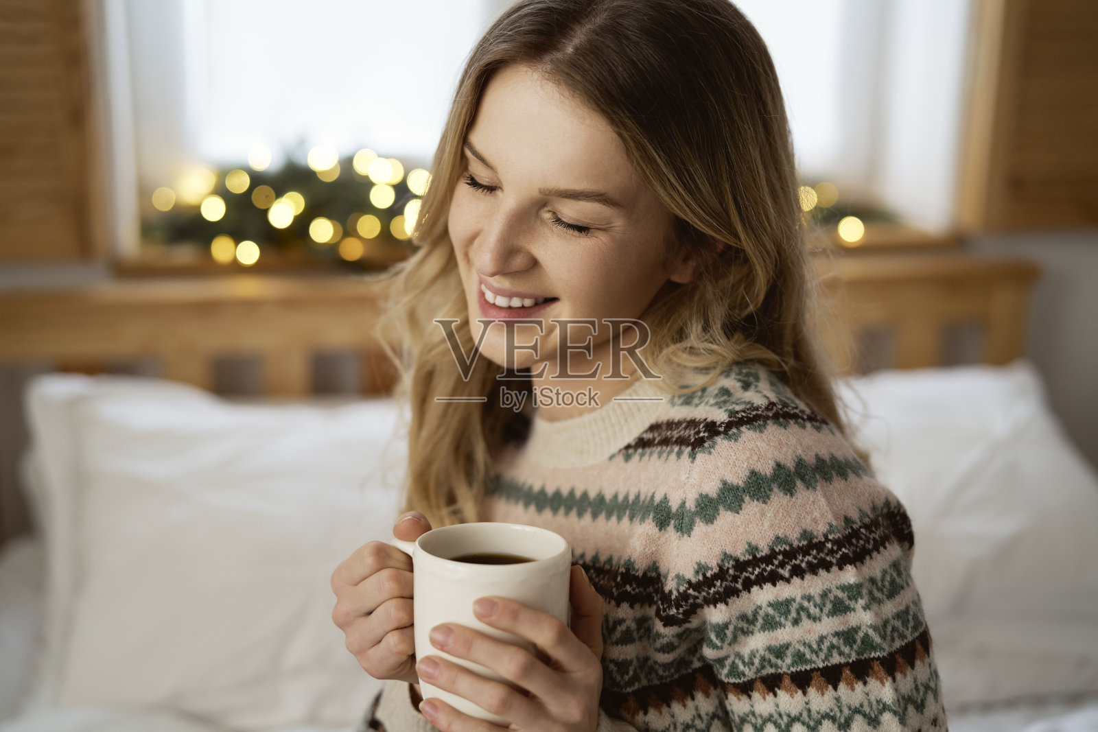 白人年轻女子坐在床上喝咖啡照片摄影图片
