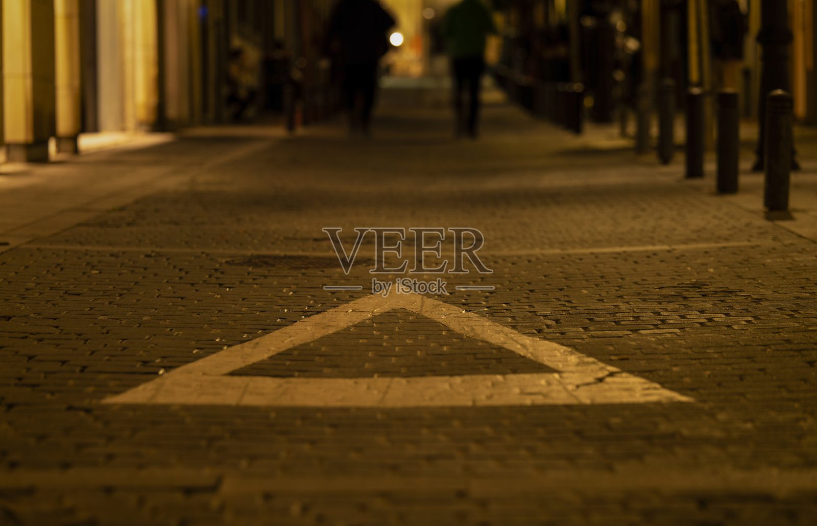 夜晚街道上的白色三角标志。马德里,西班牙照片摄影图片