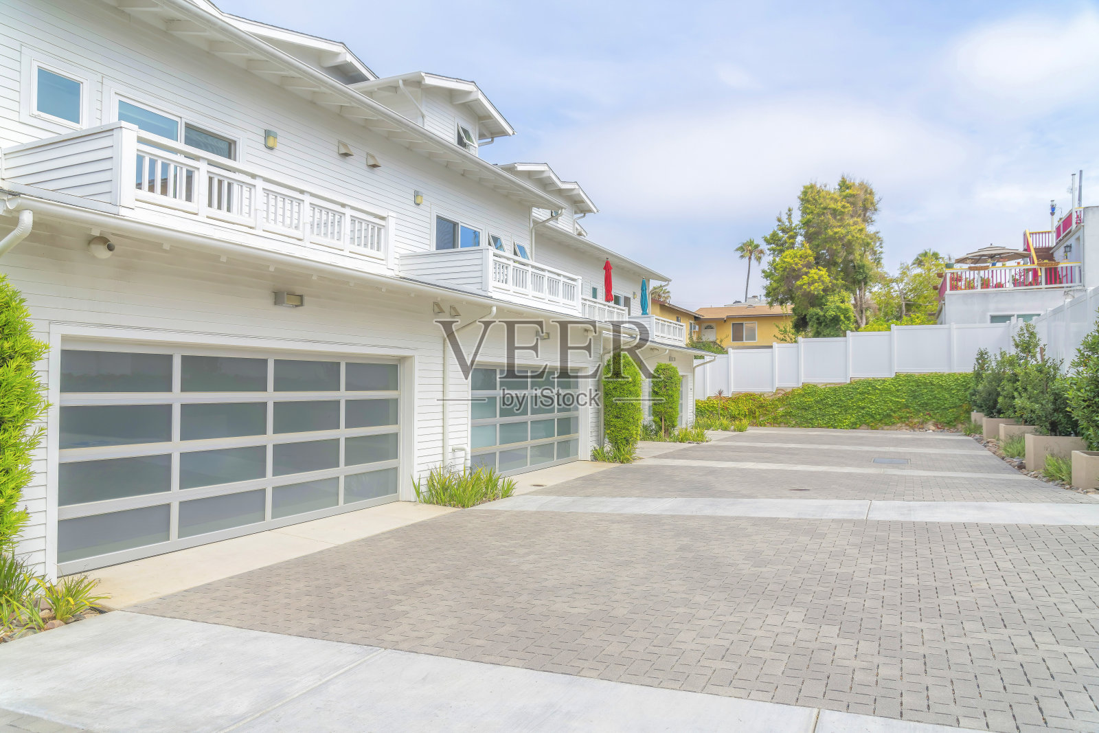 在卡尔斯巴德，圣地亚哥，加利福尼亚州，带有白色木乙烯基壁板的联排别墅外部照片摄影图片