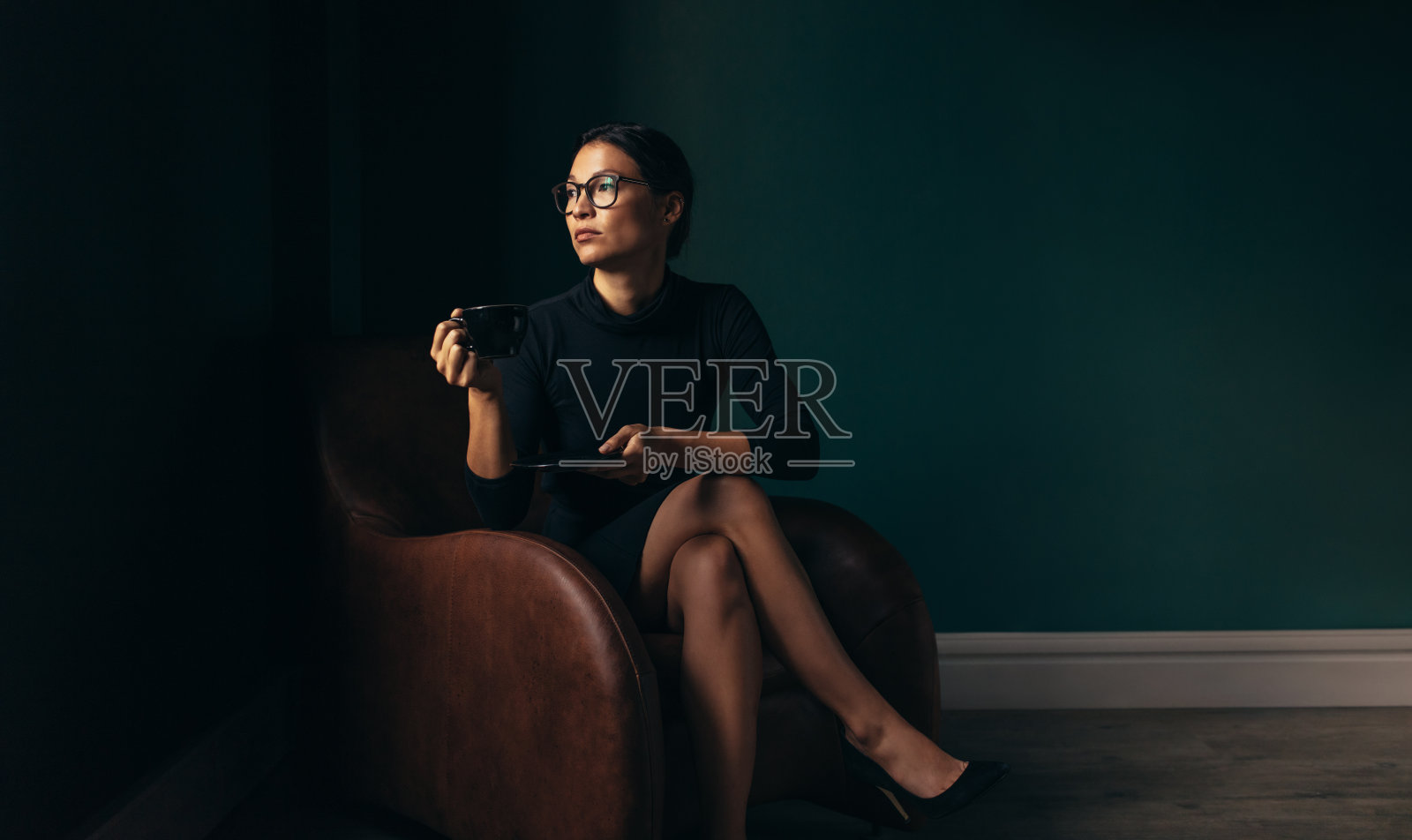 女商人坐在椅子上喝咖啡照片摄影图片