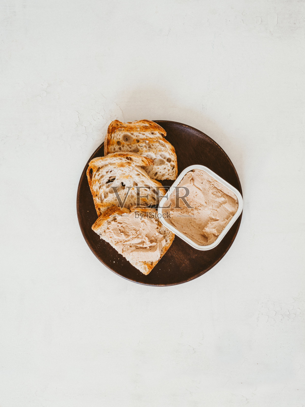 新鲜的自制鸡肝酱吐司自制面包盘在桌子上。照片摄影图片