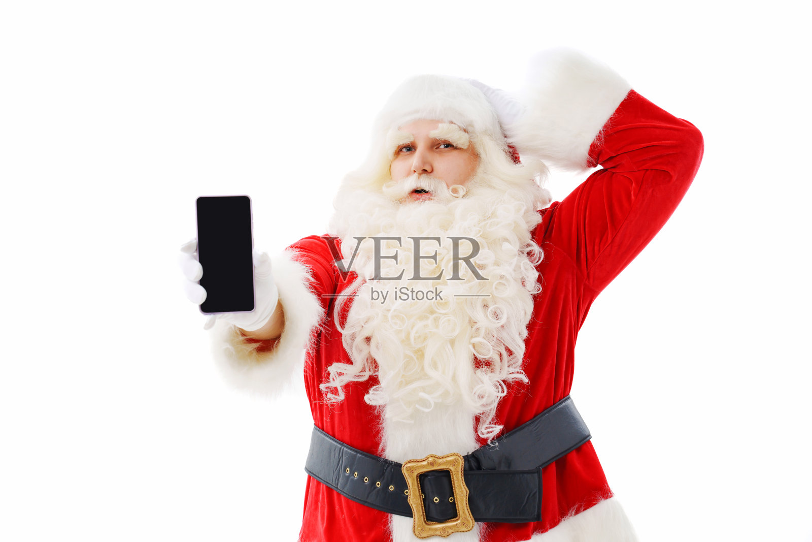 圣诞老人是白底手拿智能手机的迷茫。照片摄影图片