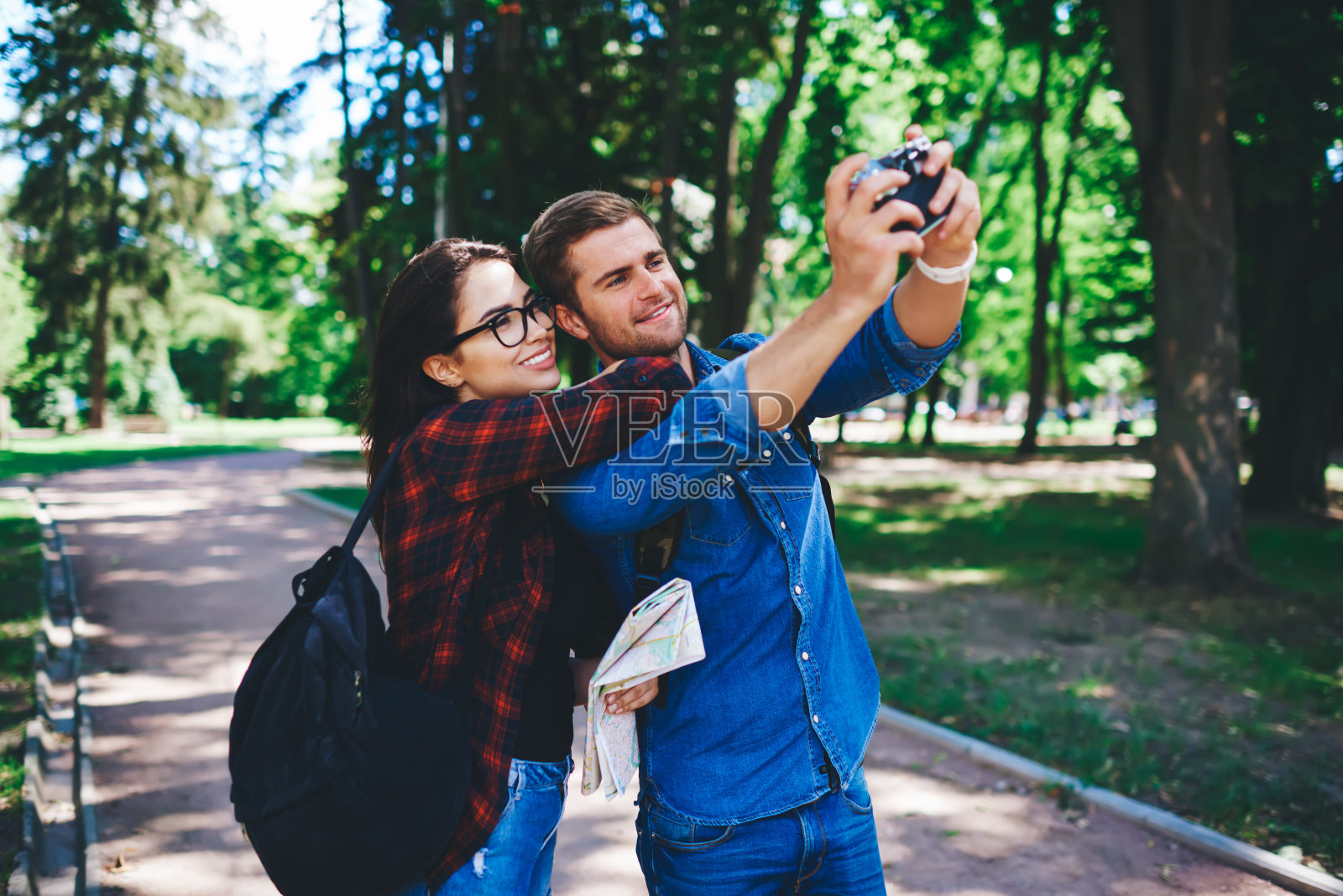 开朗的白人男女潮人在相机前摆出常见的自拍照，一起在城市旅行，开朗的情侣在爱中拍照，享受假期和旅行游览城市照片摄影图片