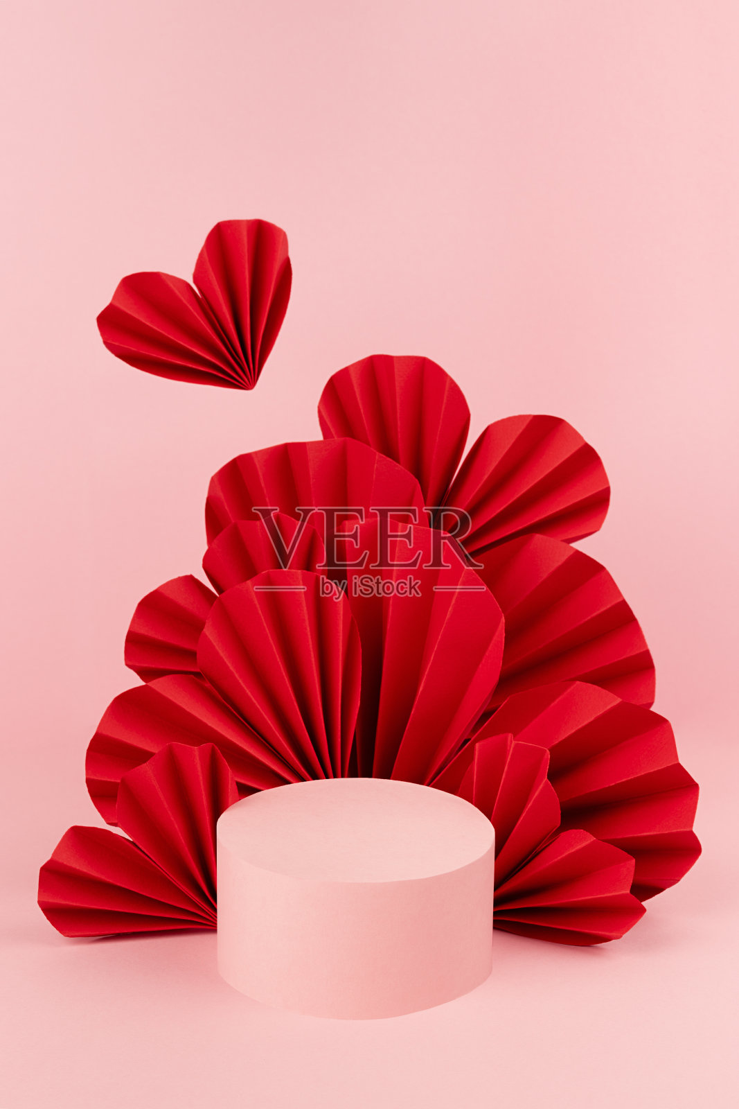 嫩红色的舞台模型与悬浮红纸心，单一的圆形讲台作为展示化妆品，广告，设计，复制空间，垂直。情人节场景模板。照片摄影图片