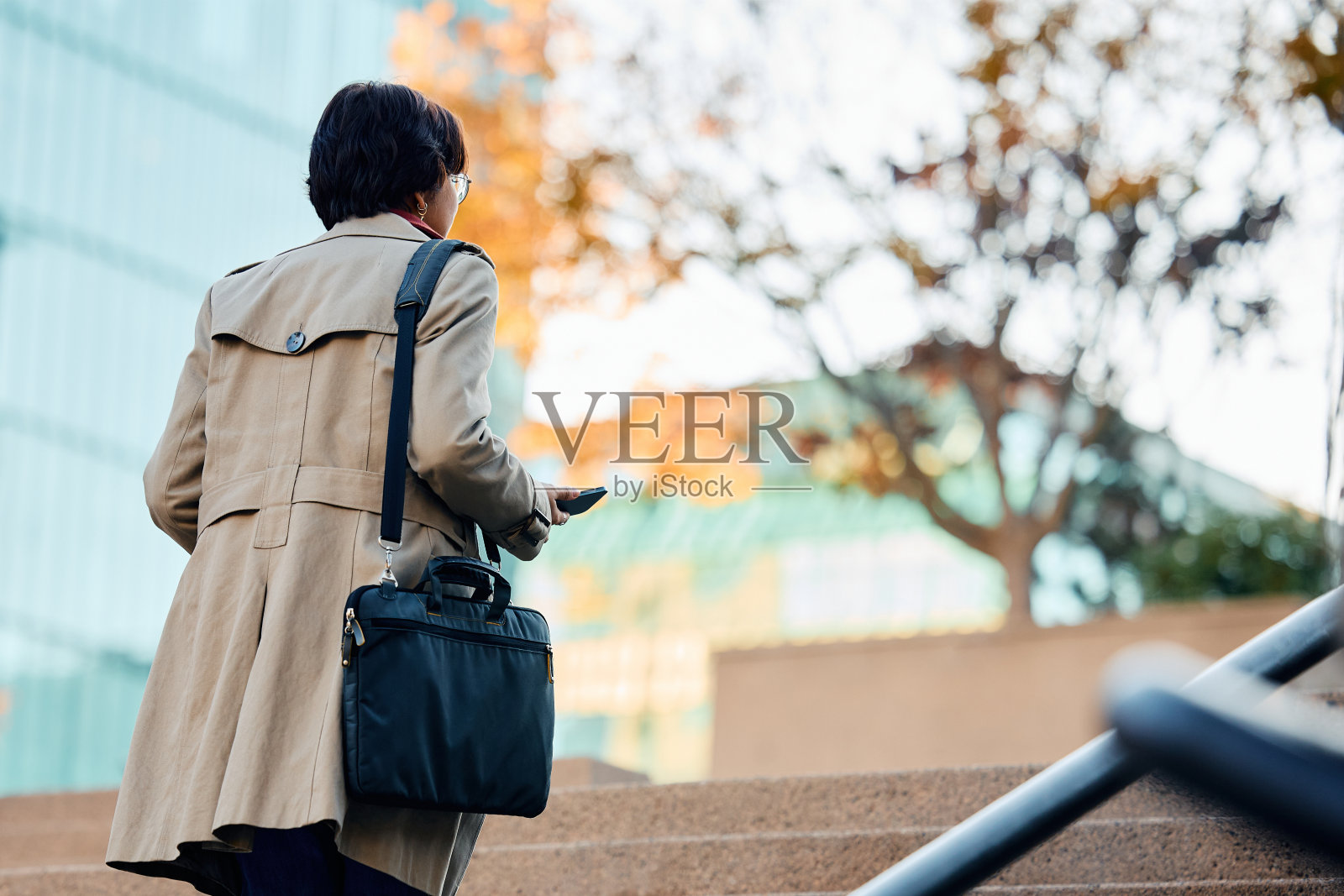 女商人走在城市的后视图。照片摄影图片