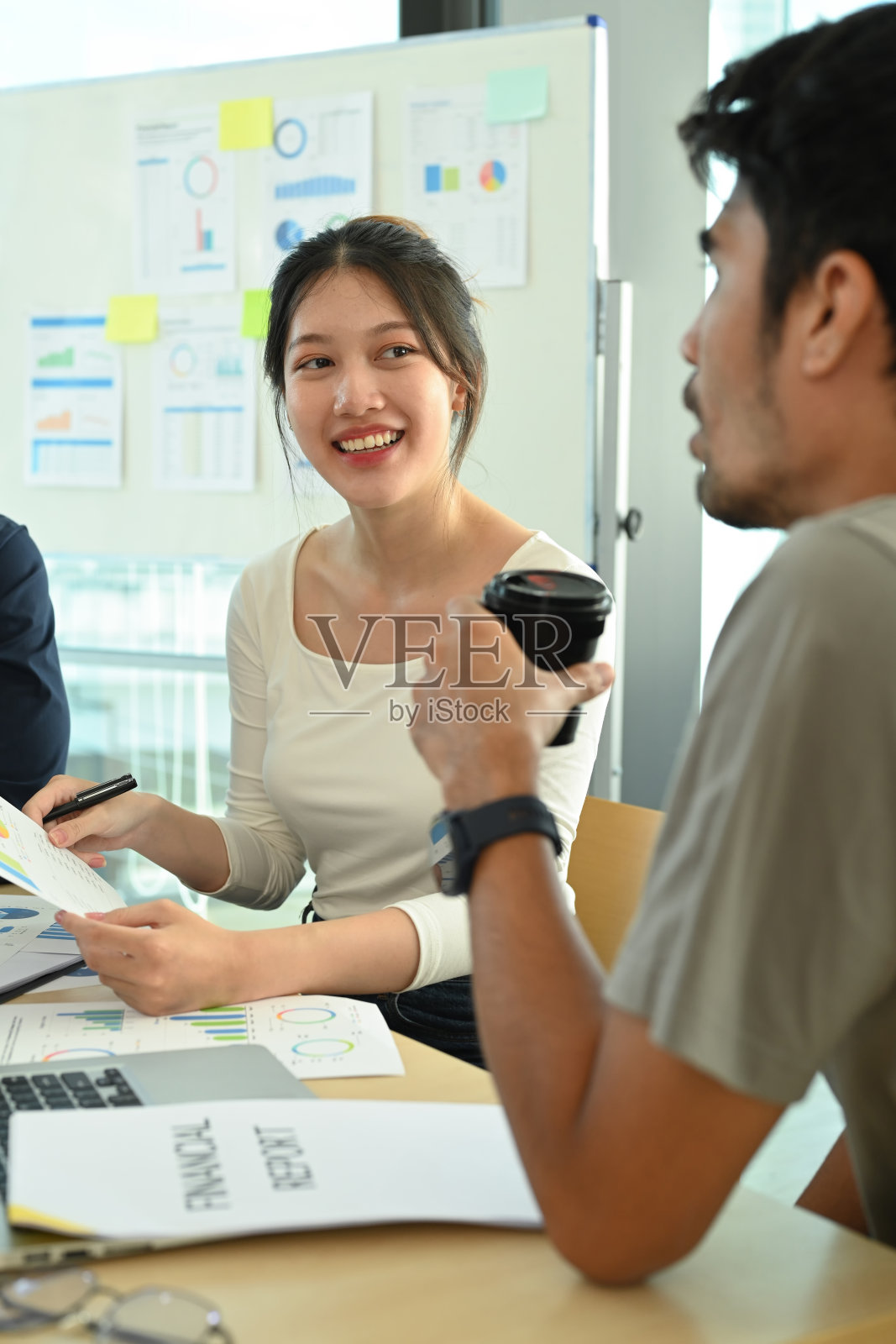 年轻迷人的女员工在公司会议上与同事分享商业战略。照片摄影图片