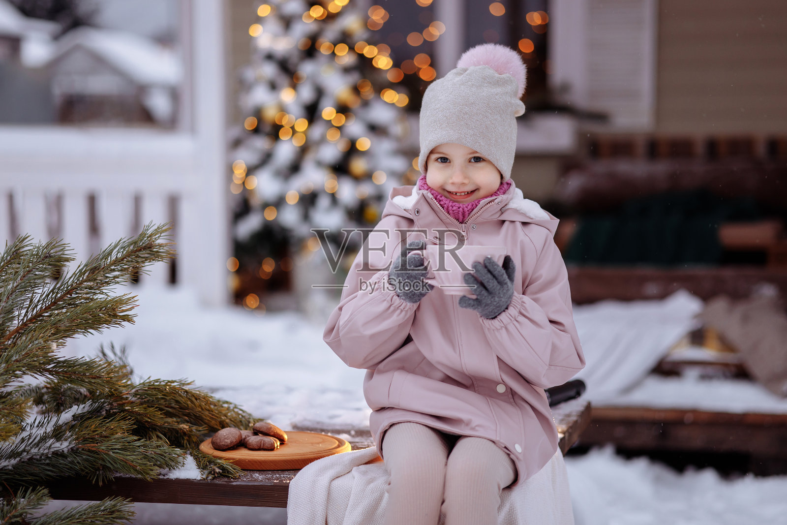 快乐可爱的女孩坐在门廊上过圣诞节照片摄影图片