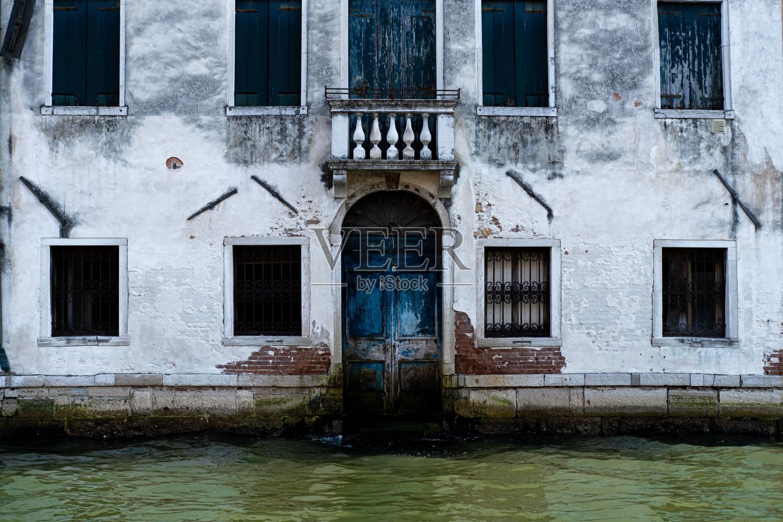 在意大利威尼斯，被水包围的蓝色门照片摄影图片