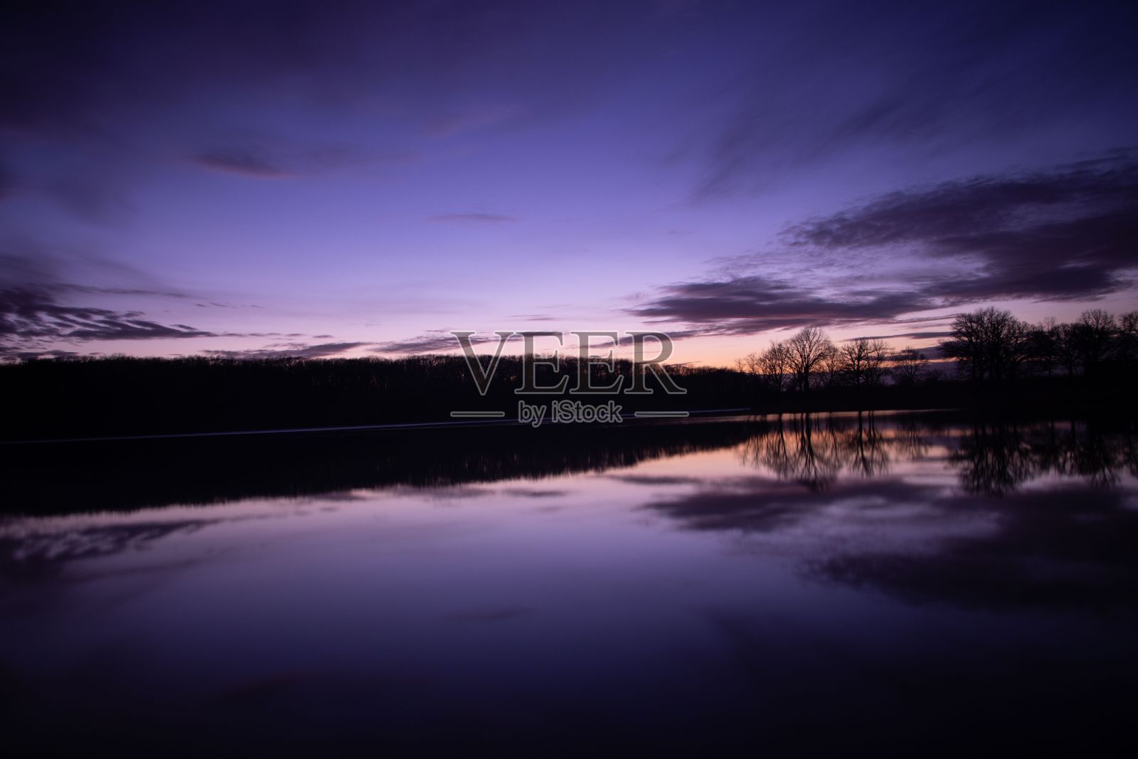 丁香色的夕阳映在湖面上的水面上照片摄影图片