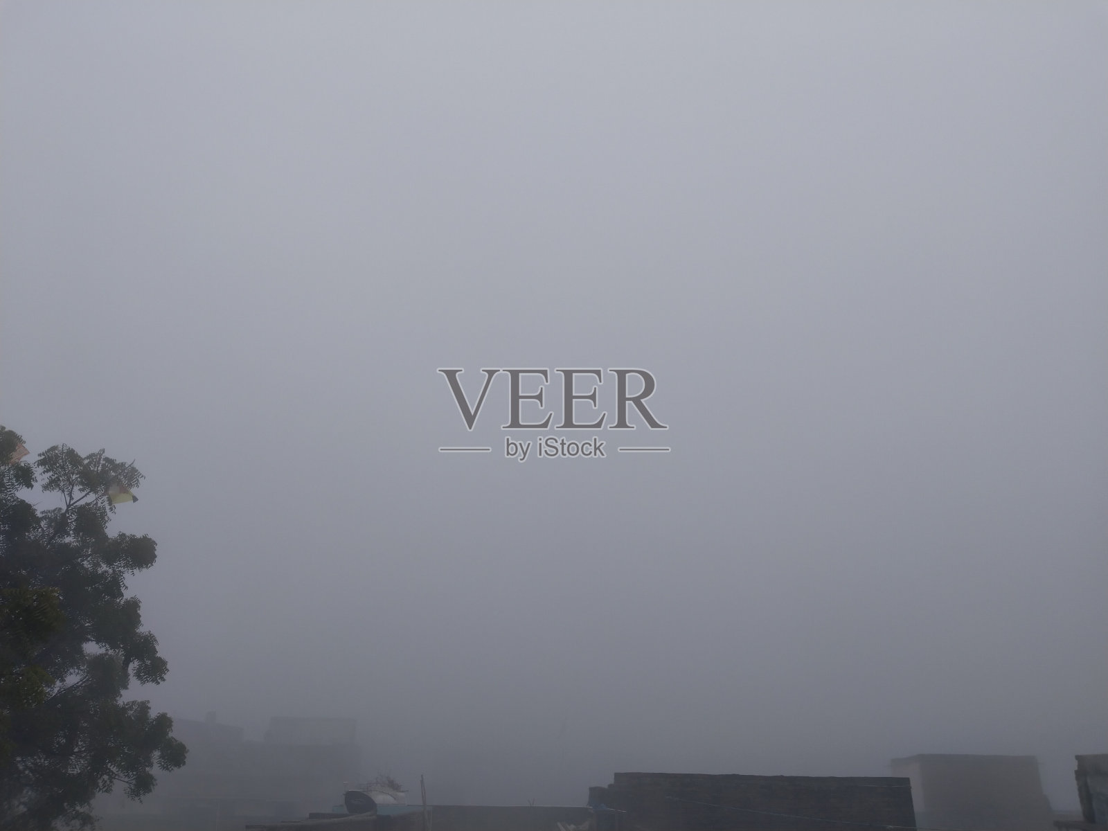 在印度村庄的房屋上雾蒙蒙的天空。照片摄影图片