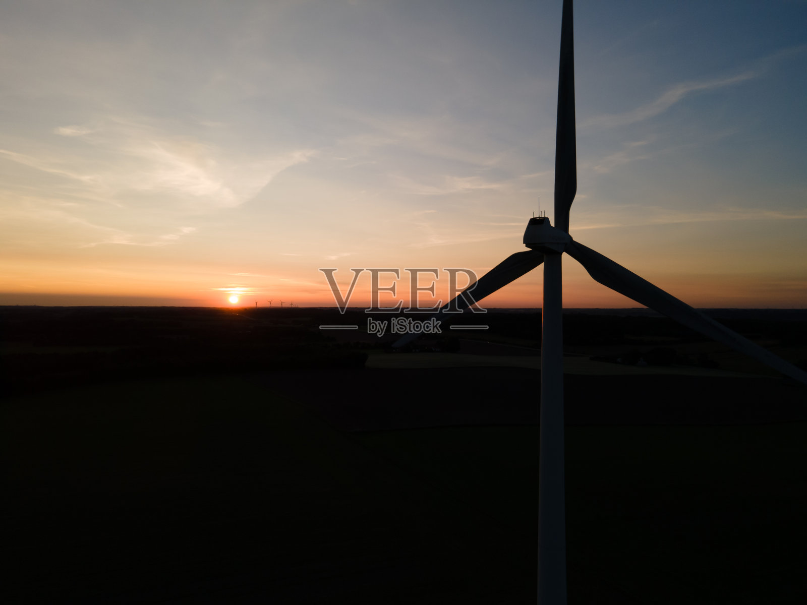 夕阳下风车的剪影照片摄影图片