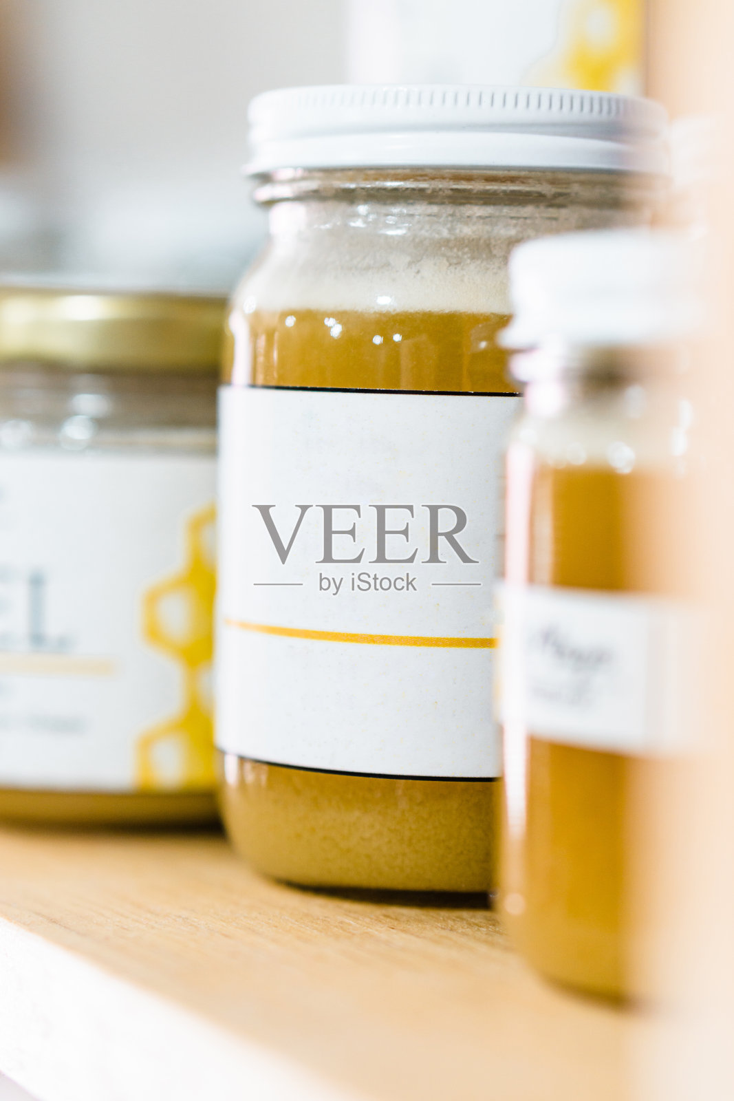 空白标签的蜂蜜罐。架子上的物体。照片摄影图片