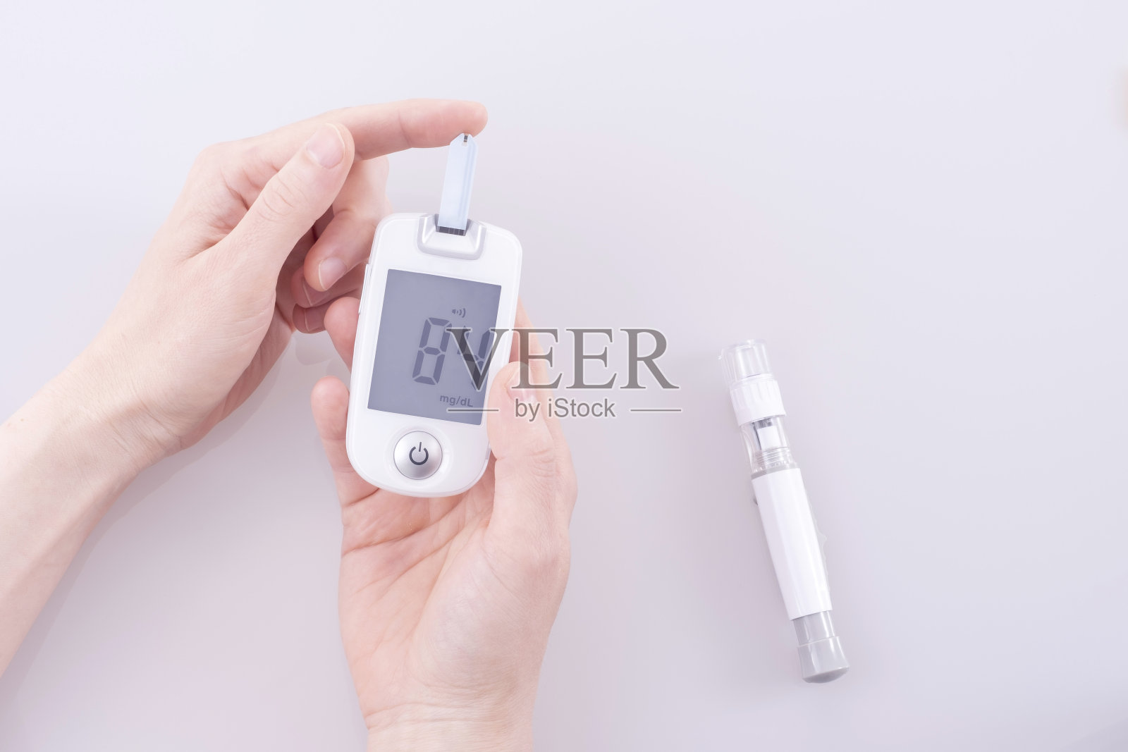 人类使用血糖仪从手指上测量和测试血糖水平。照片摄影图片