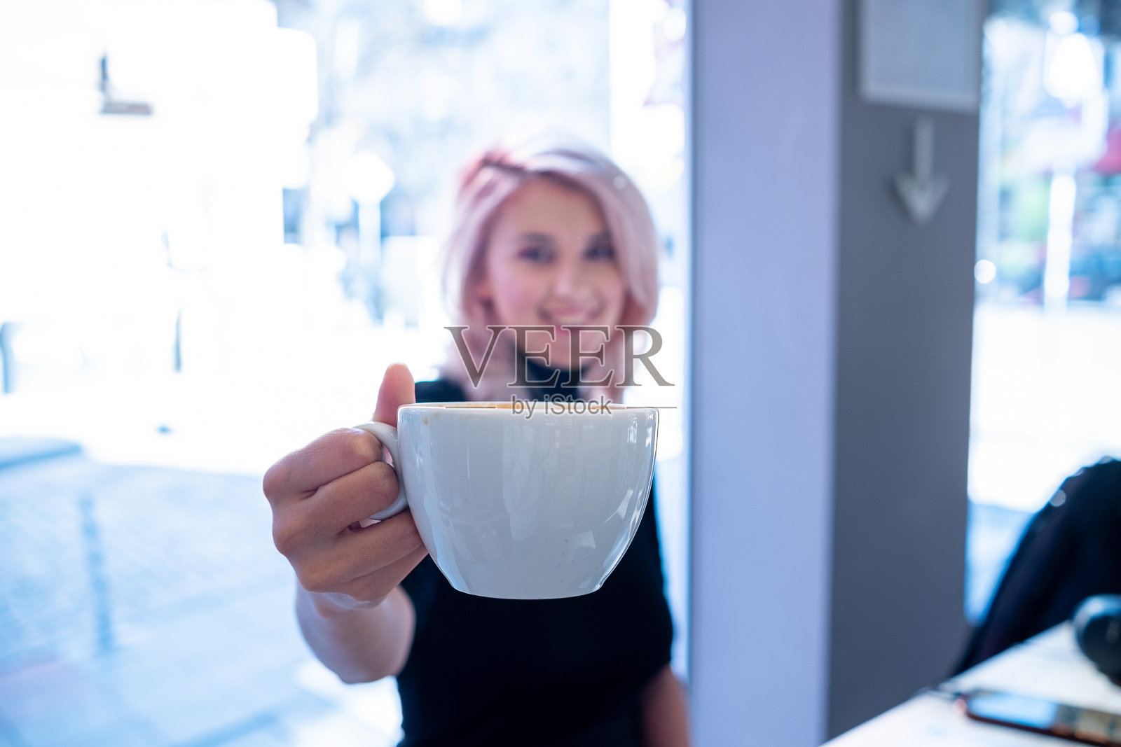 快乐的女孩在咖啡馆里喝咖啡照片摄影图片