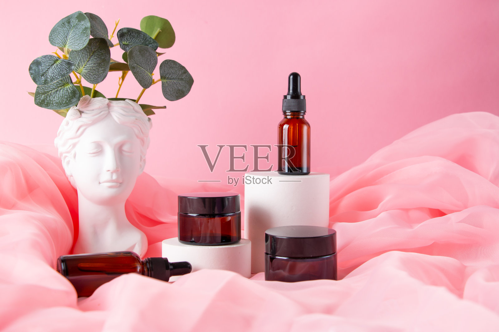 希腊女神半身像和化妆玻璃罐粉彩背景。最小的平面静物。美丽的开销的概念。照片摄影图片