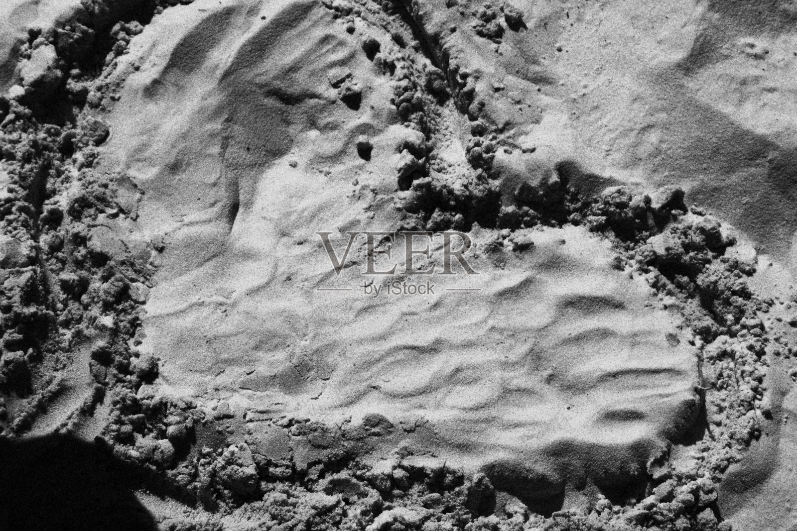 在沙滩上的沙子上画一颗心。黑白单色照片摄影图片