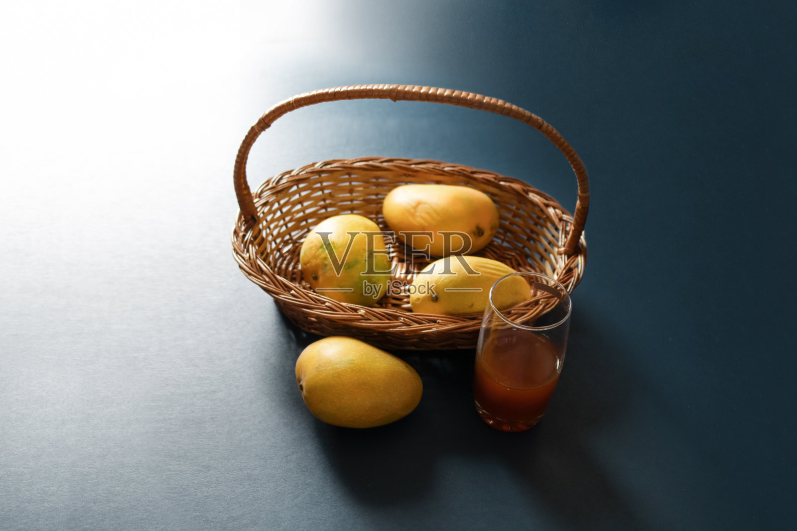 芒果在篮子里，蓝色，黑色的背景芒果水果俯瞰照片摄影图片