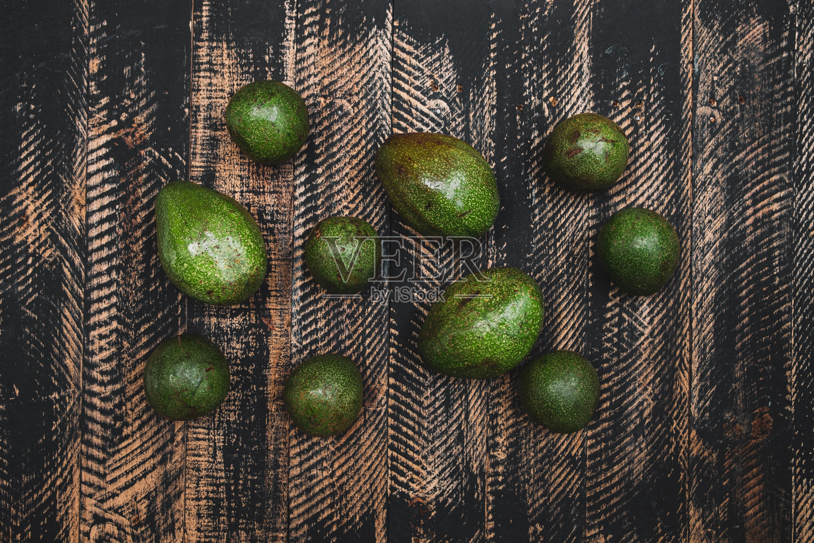 整只和对半的牛油果放在木桌上照片摄影图片