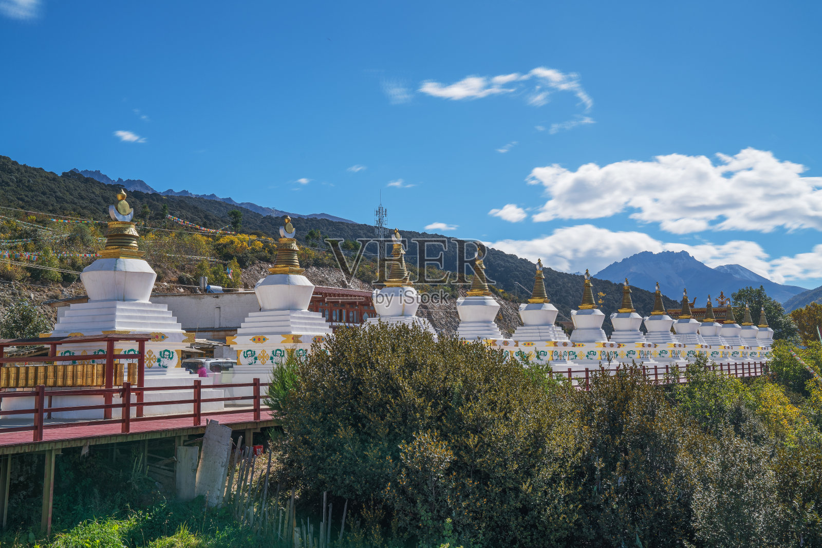 美丽的美丽雪山和寺庙建筑白塔在中国云南省照片摄影图片