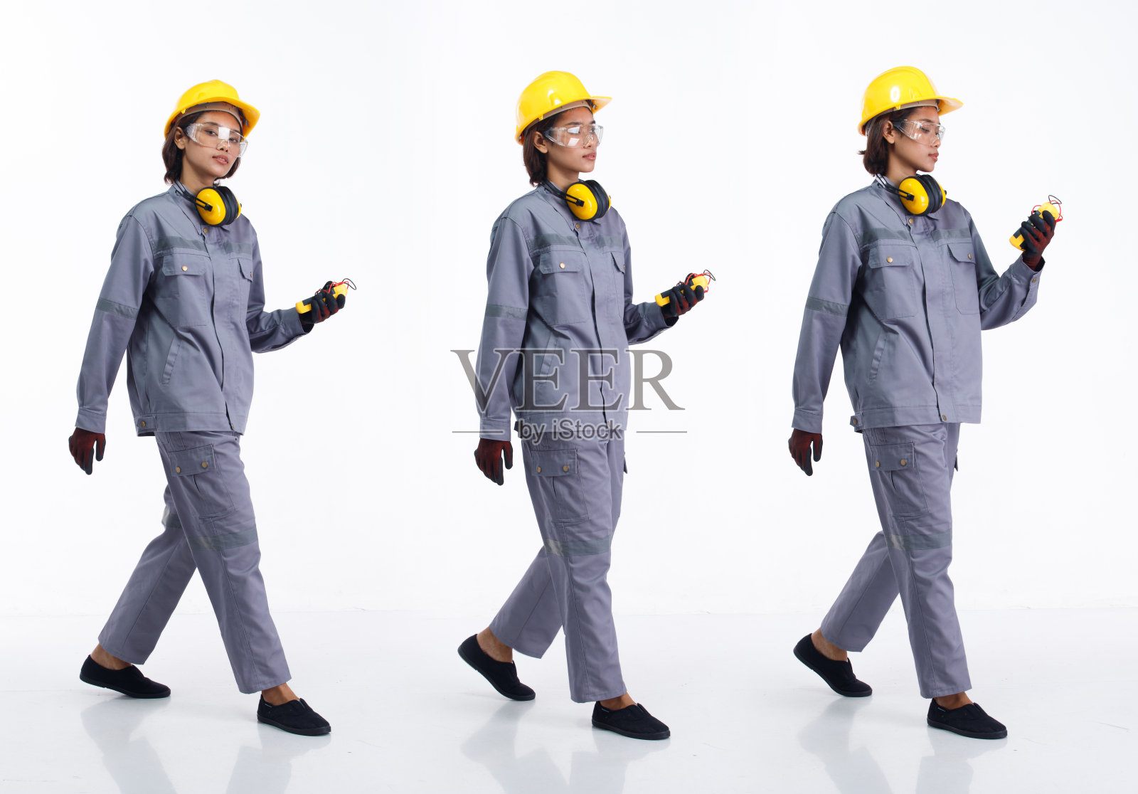 全长20岁的年轻亚洲工业女性戴安全帽保护装备，向前走左右照片摄影图片